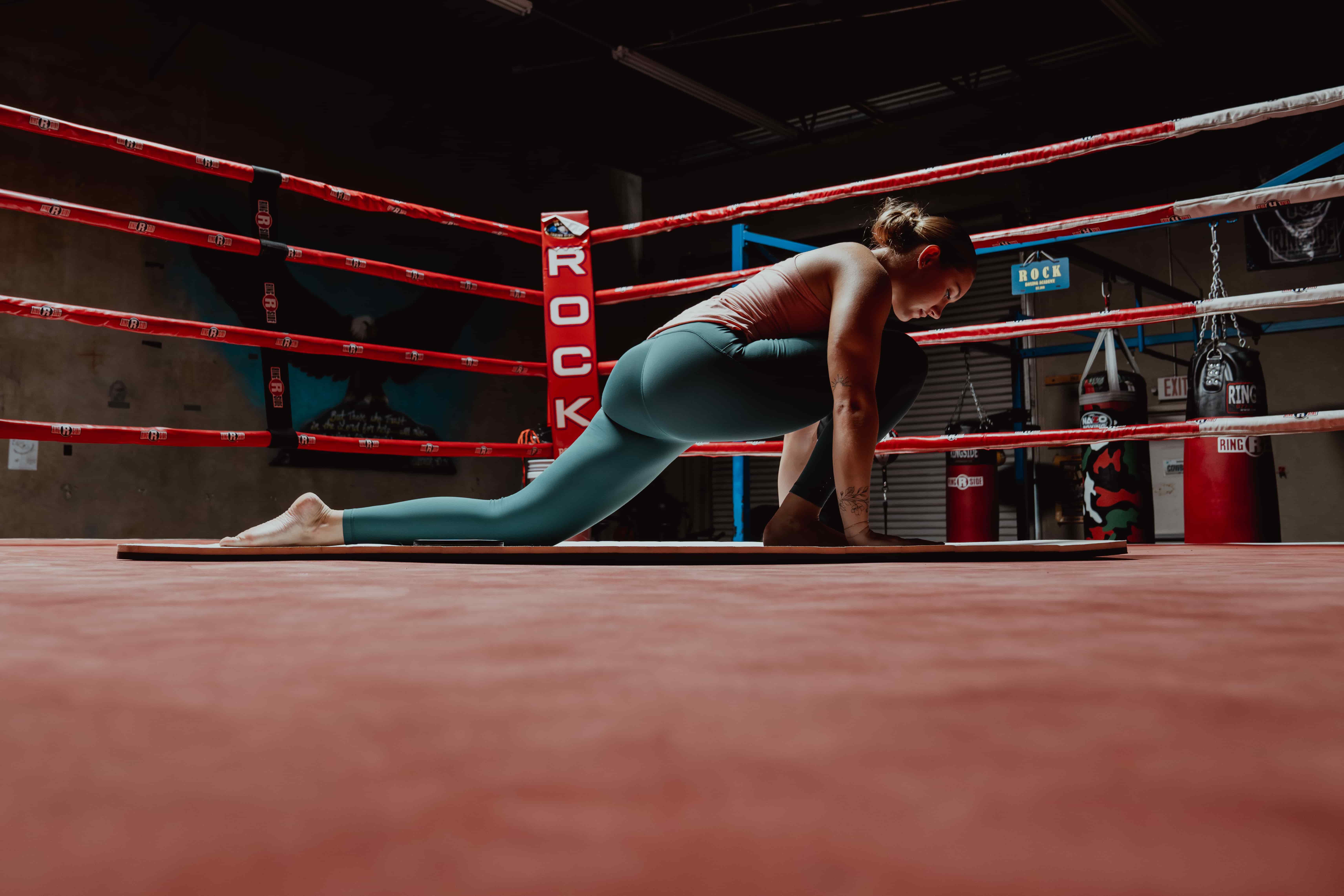 Woman Stretching in Boxing Ring - Stretch Before Or After Workout