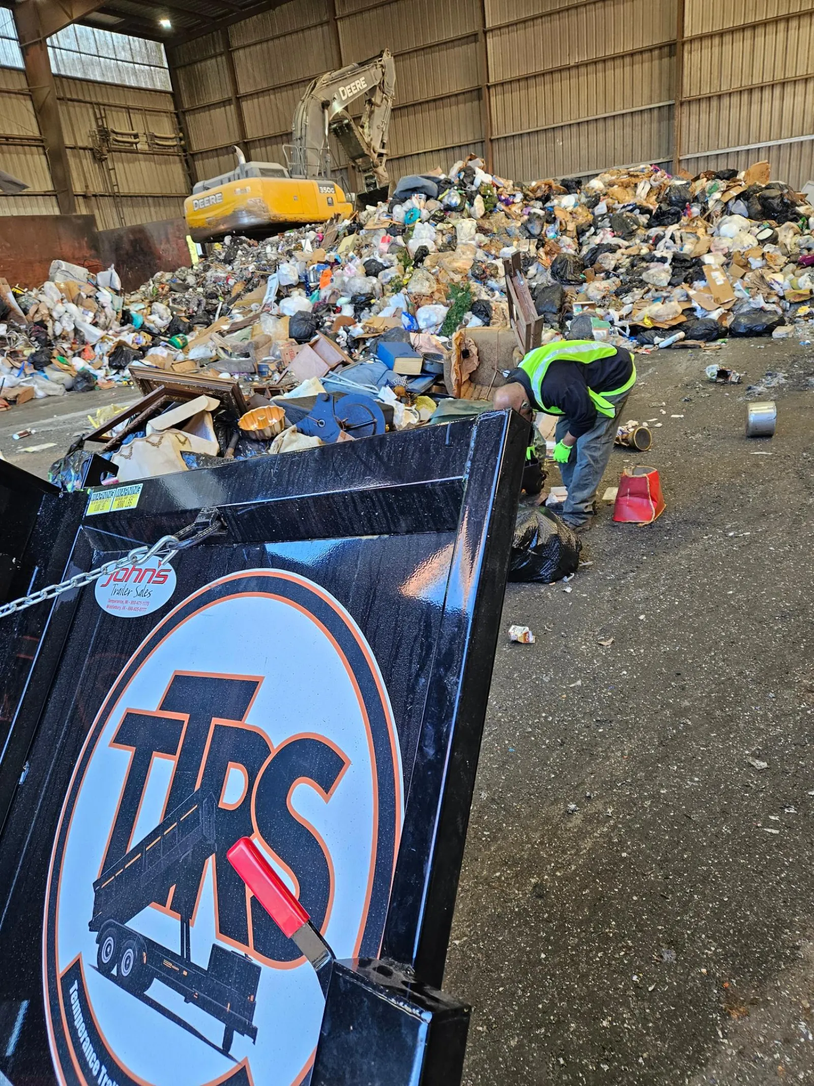 TTRS logo on a dump trailer at the transfer station with jobsite debris