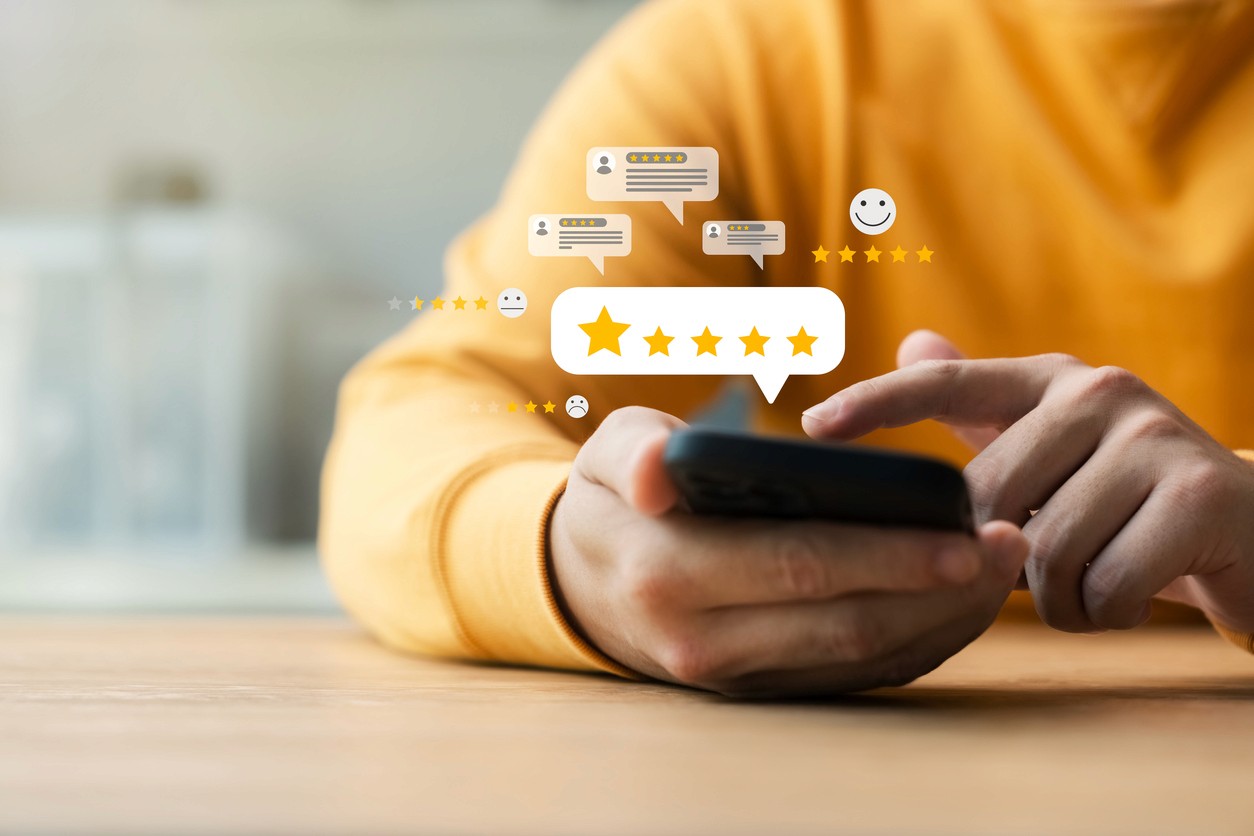 Person using smart phone for online reviews
