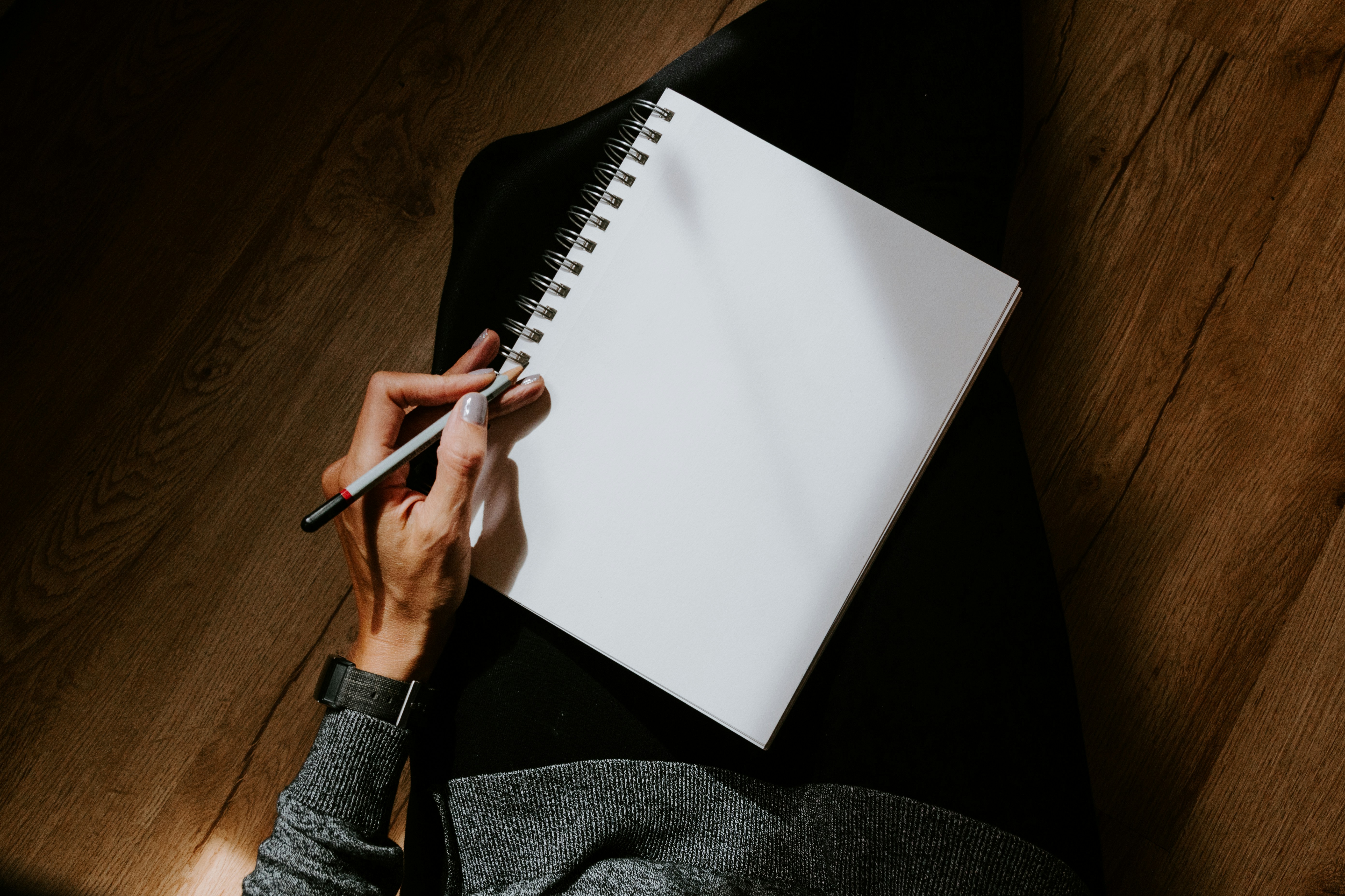 woman writing on blank paper - how to write gospel songs