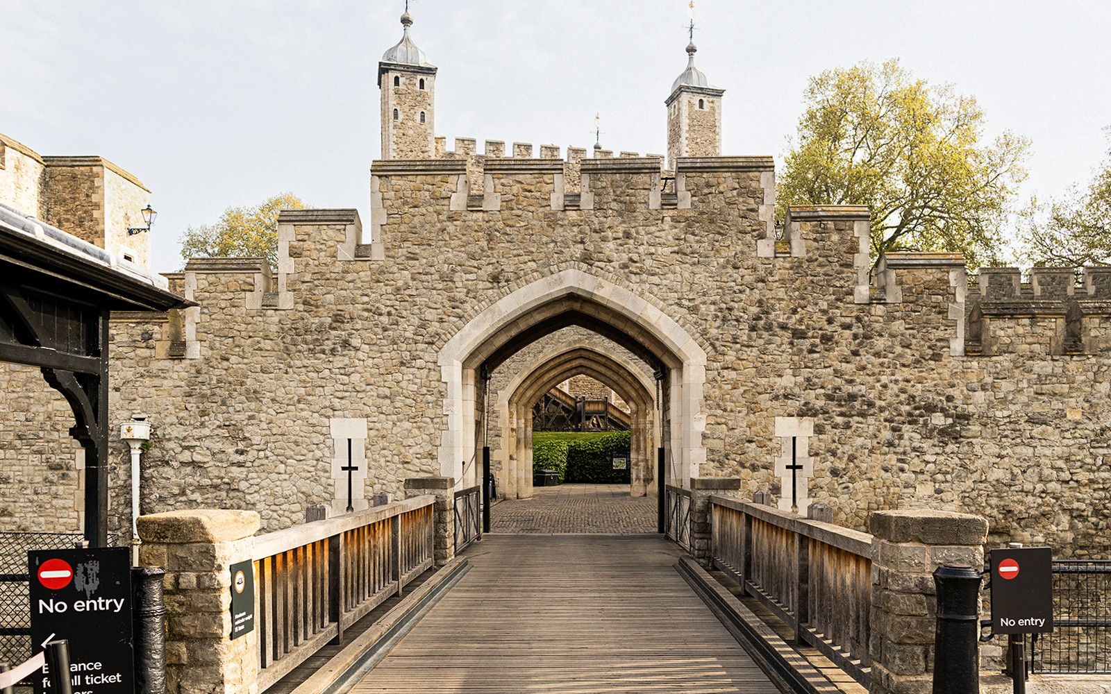 Tower of London entrance with stone archway and historic walls.