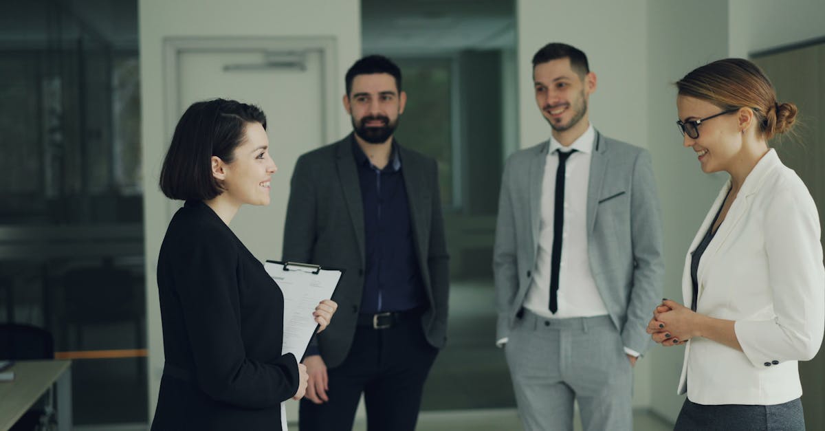 Group of professionals discussing strategy in a modern office setting.