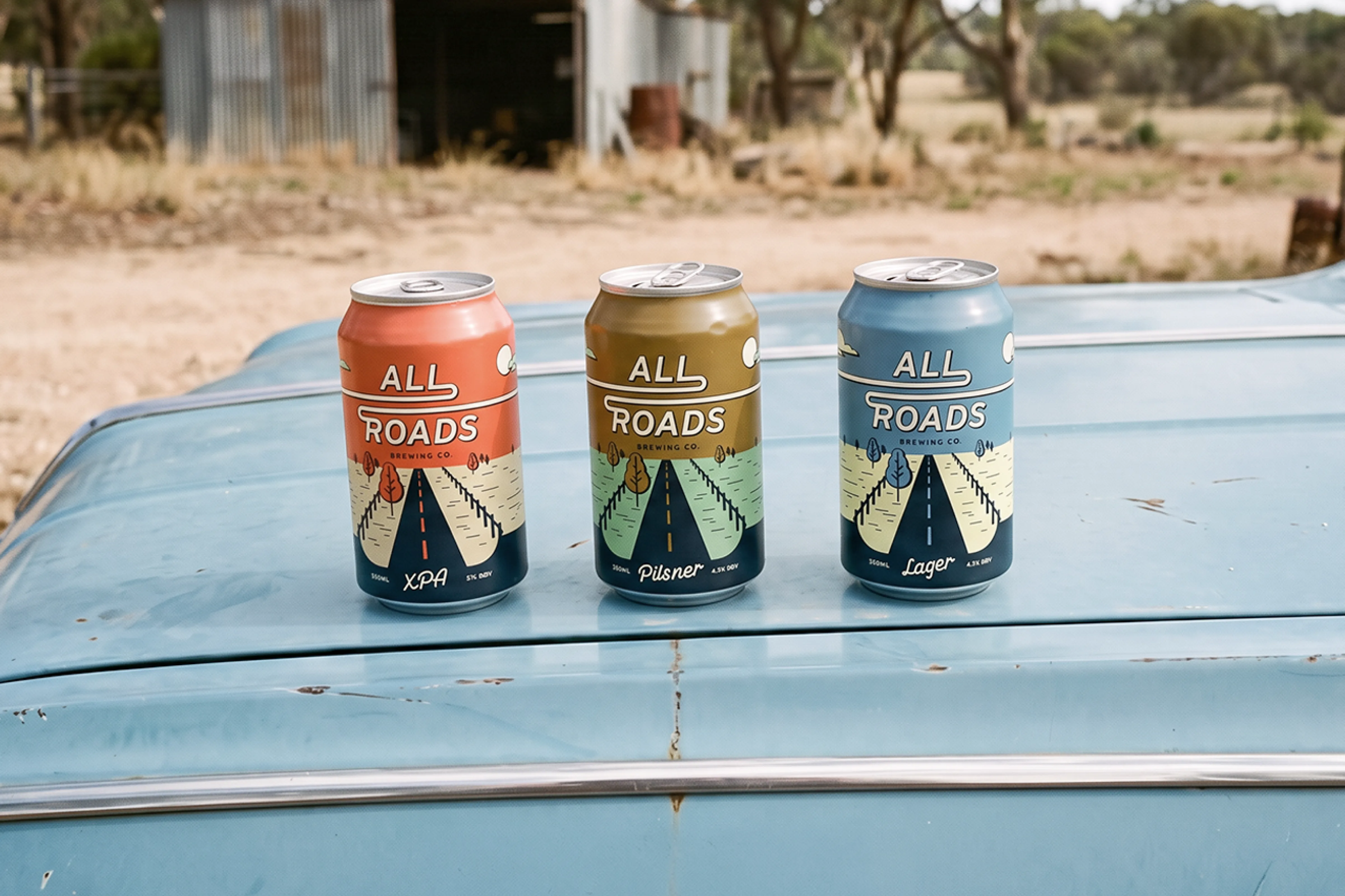 All Roads Brewing Co. XPA, Pilsner and Lager cans on a truck roof