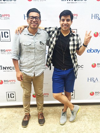 A photo of a two man standing in front of a commercial table.