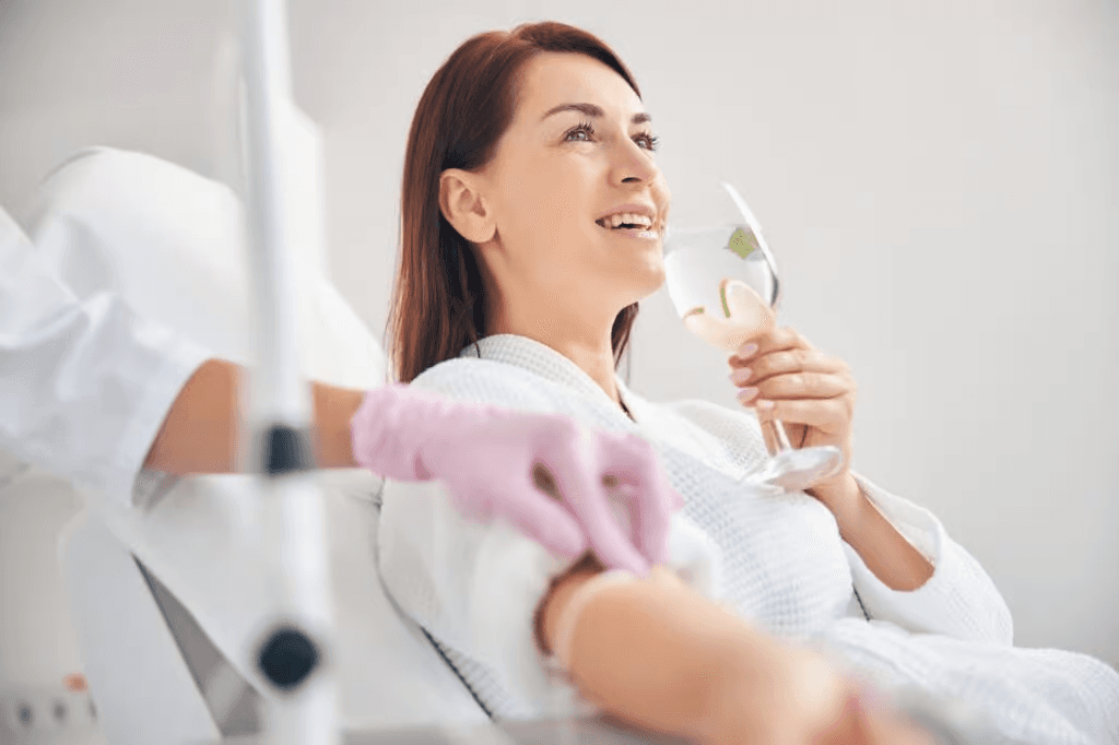 Woman on IV drip drinking lemon water