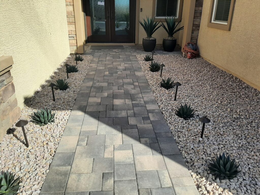 FreshStart Landscaping Vegas desert front yard with decorative rock ground cover drought tolerant plants and boulders