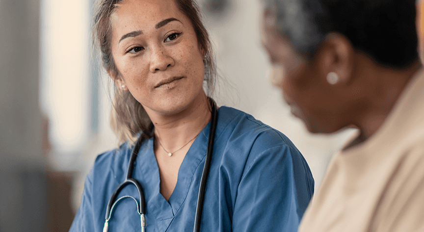 Physician speaking with a patient, representing the in-depth interviews and dyads Public Works uses to understand lived experience and inform human-centered design