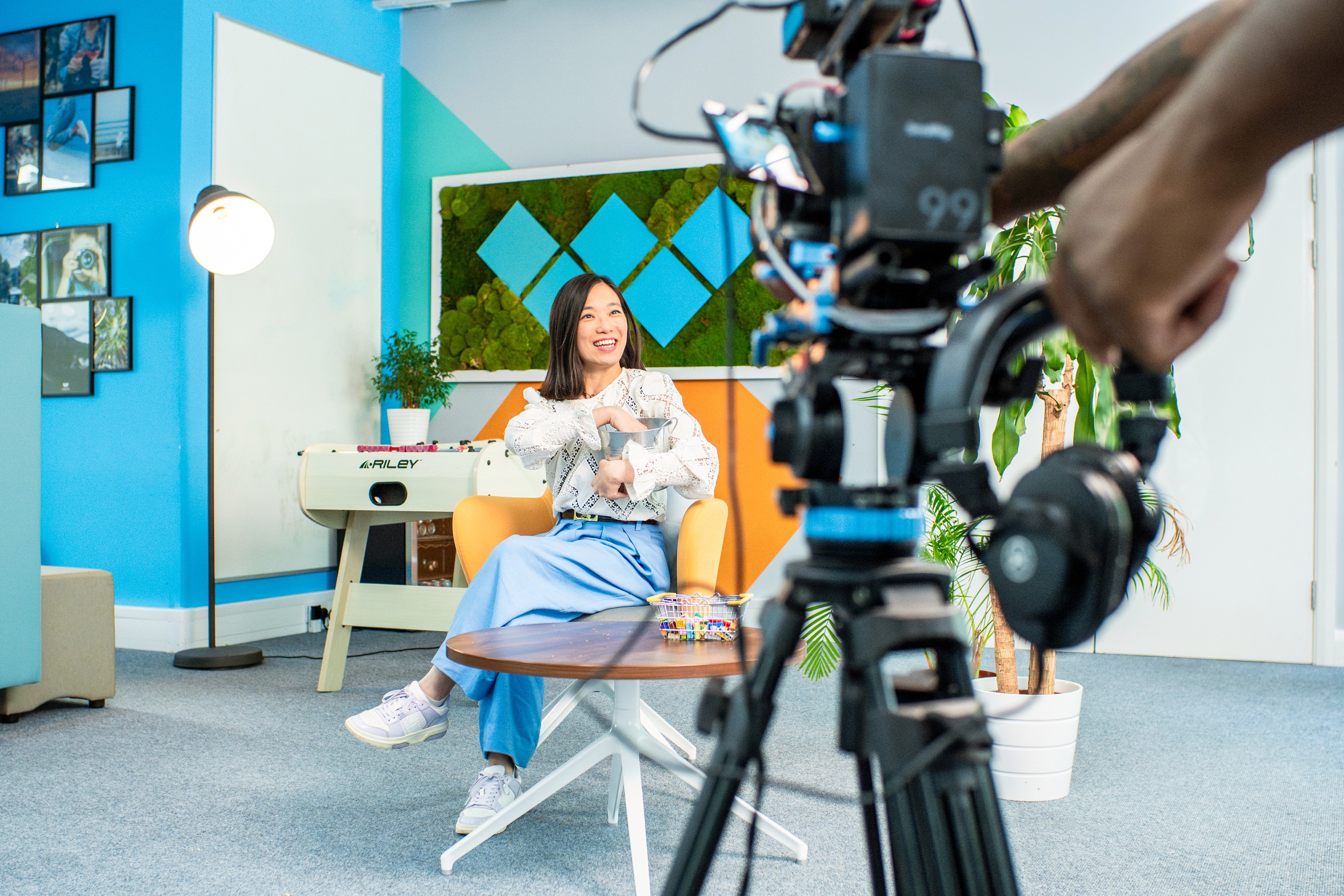 Woman filming social media content in front of cinema camera