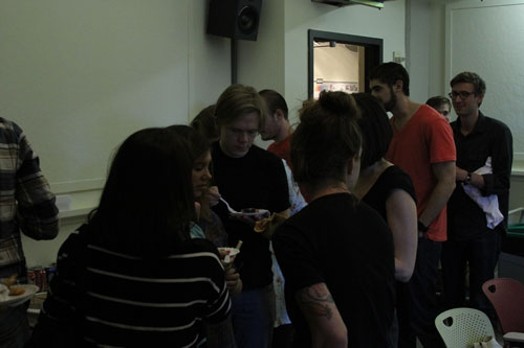 A photo of a group of students talking in the hallway.
