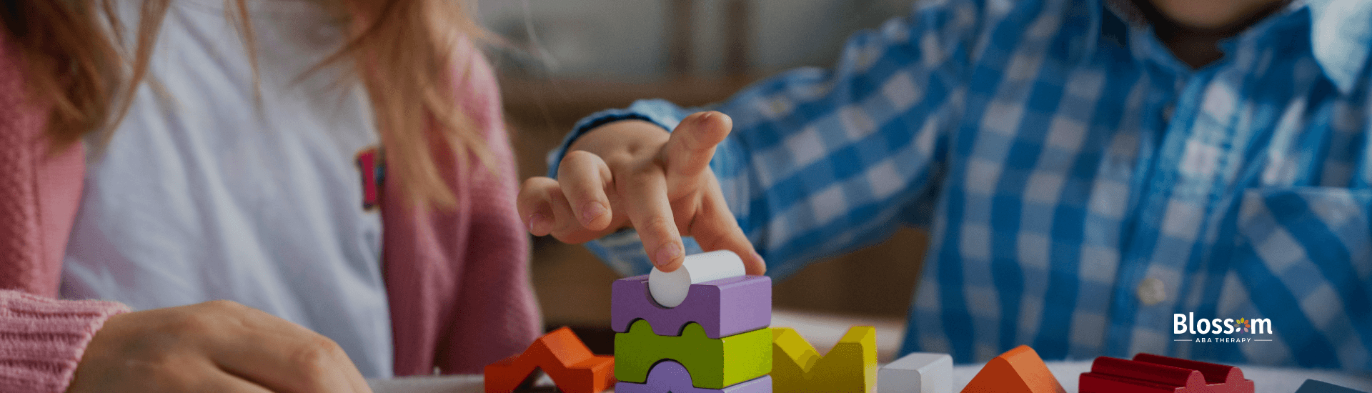 Two children engaged in a puzzle activity at a table.