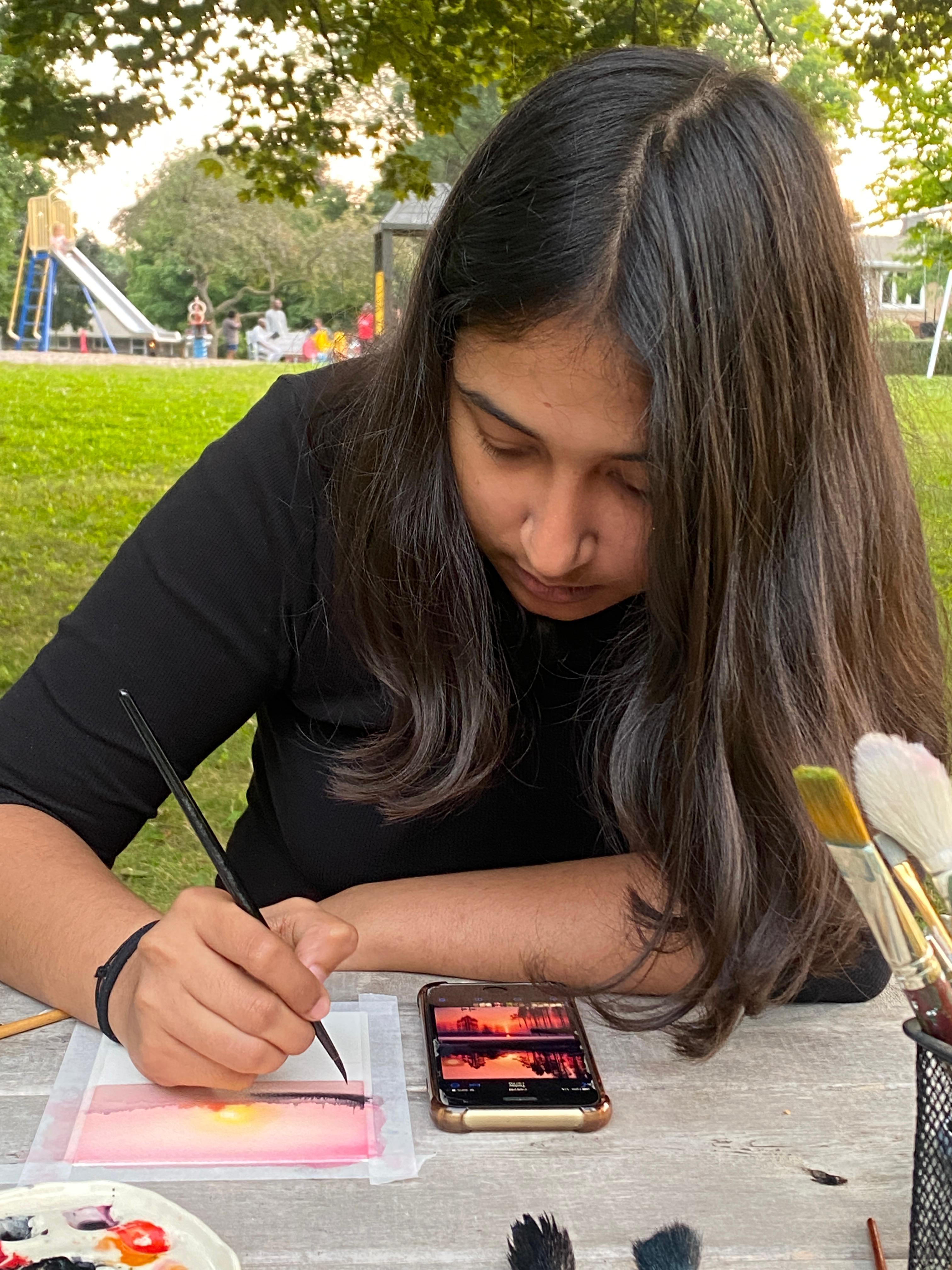 Laptop screen displays a cityscape next to lit candles.