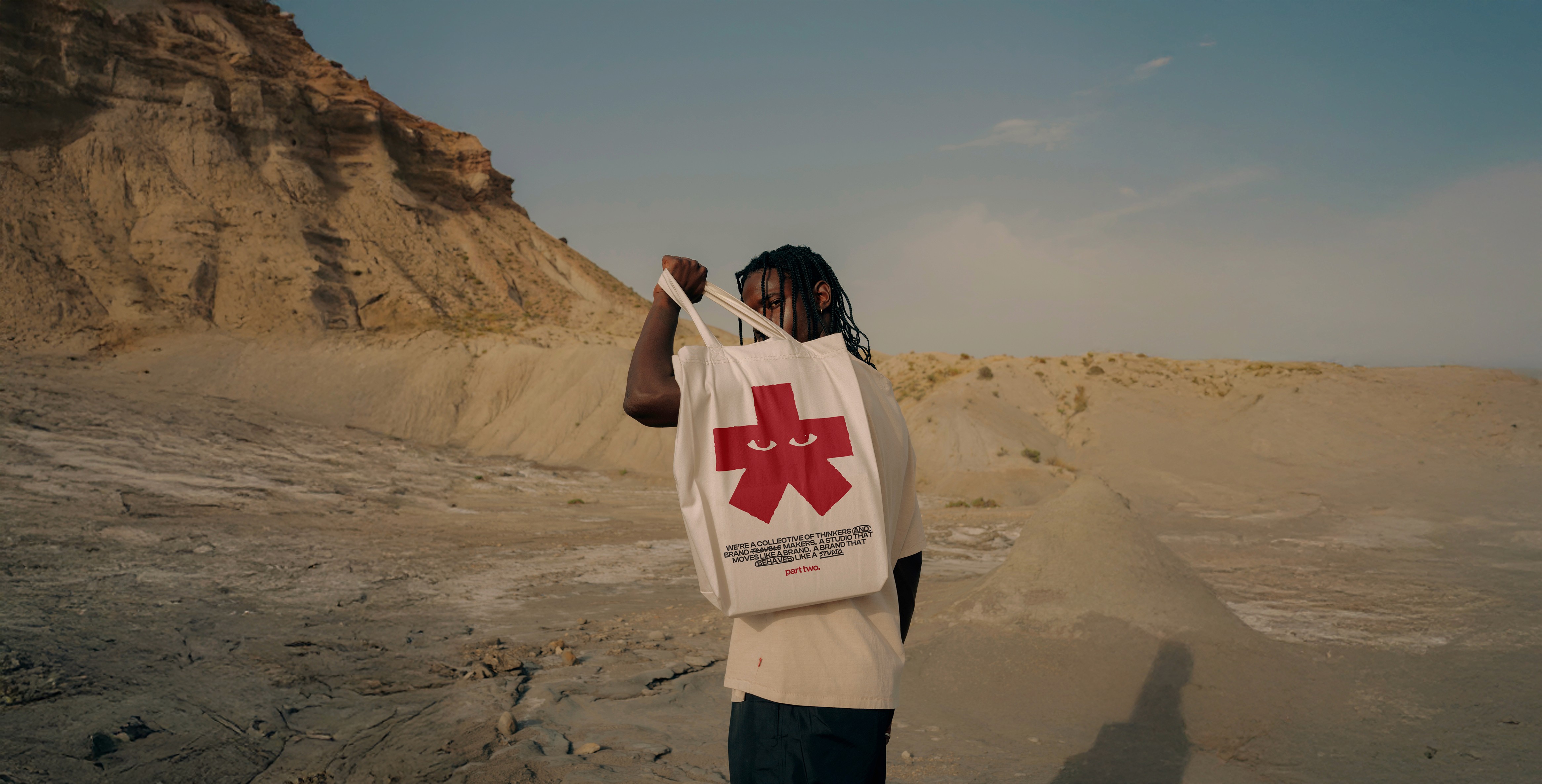 Model holding up a Part Two branded tote bag