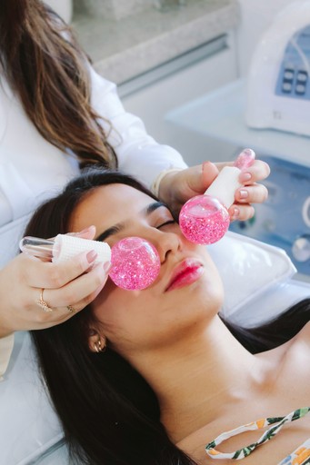 A woman getting her make - up done by a professional make - up artist
