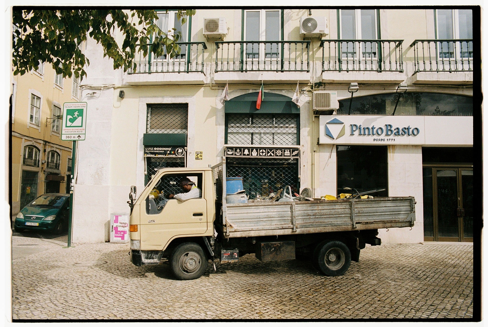 Modern skyscrapers line a busy highway in a sprawling city.