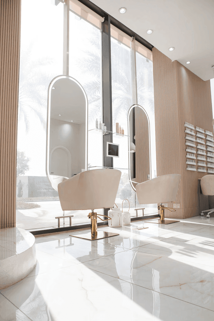 Professional hairstylist blow-drying client’s hair at Havie & Moon salon in Dubai Hills