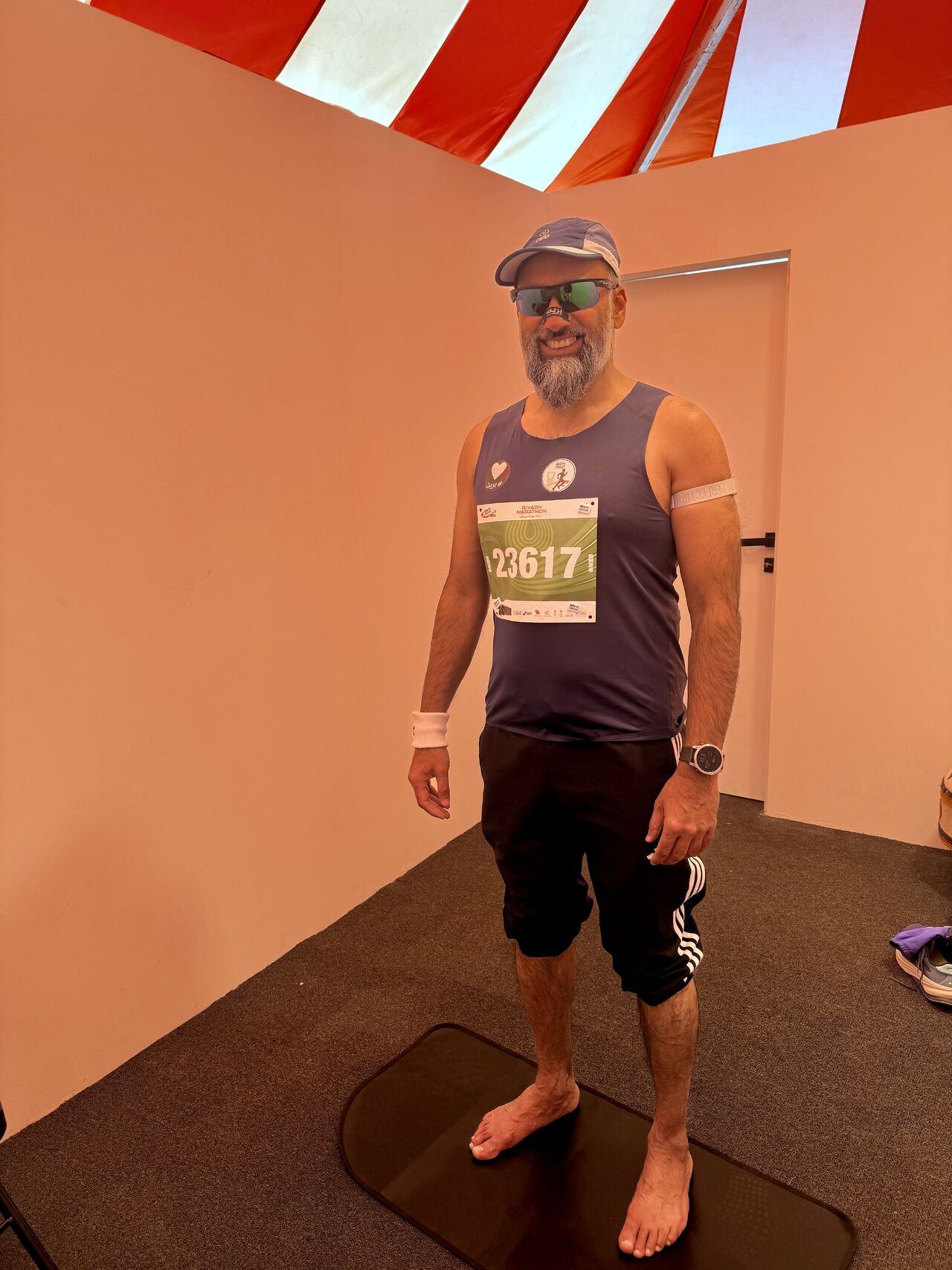A Riyadh Marathon participant standing for a full body thermal scan