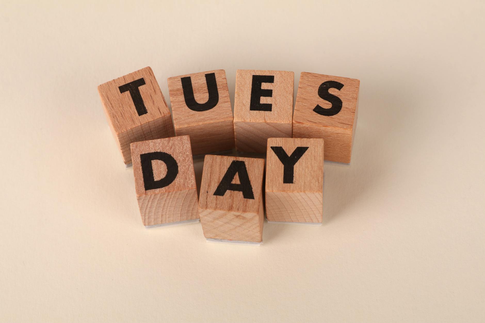 A teacher points to colorful letter magnets on a whiteboard to demonstrate phonics sounds for a small group.