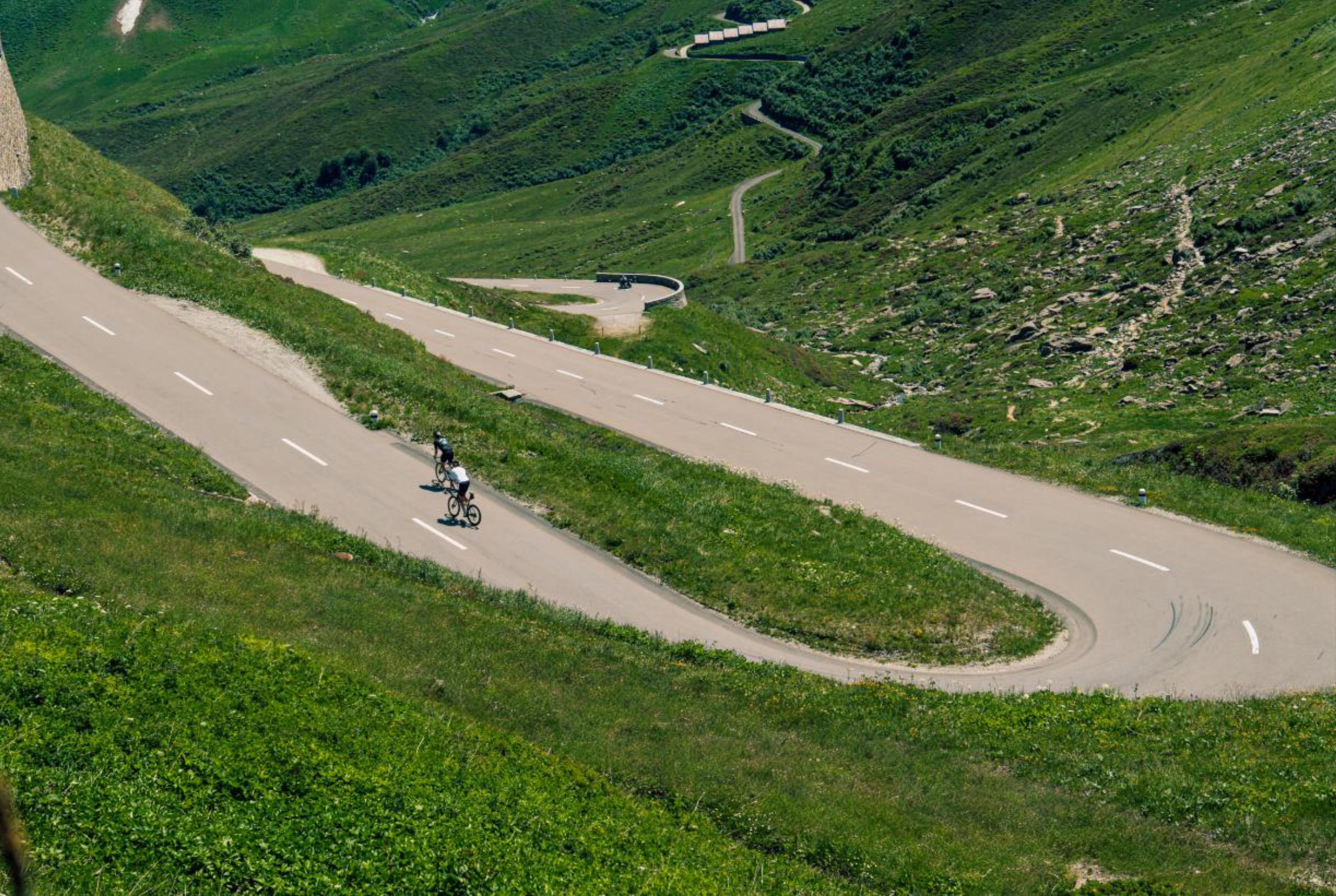 Cyclists riding up the Oberalp Pass in the Swiss Alps