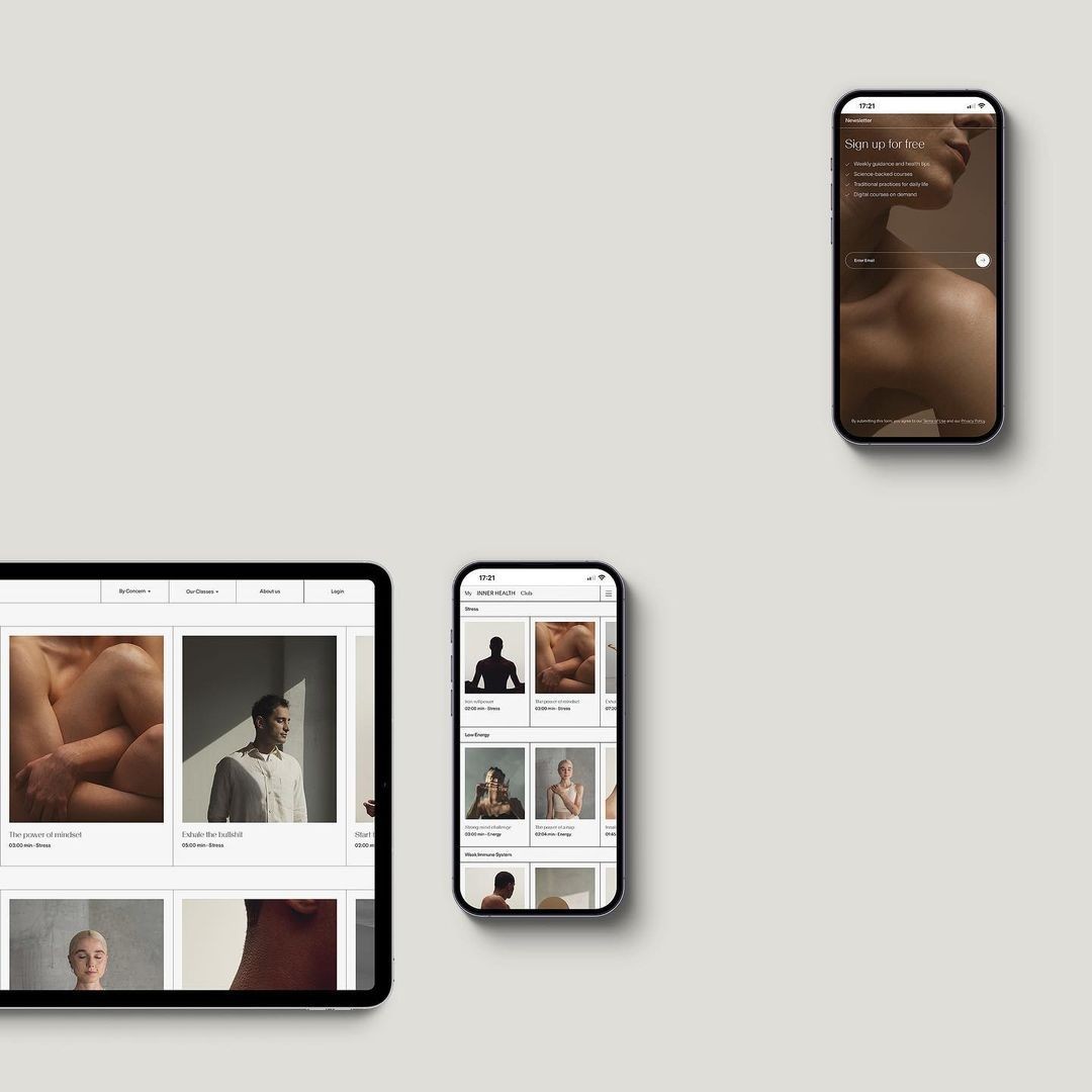 braided woman taking photo beside yellow painted wall