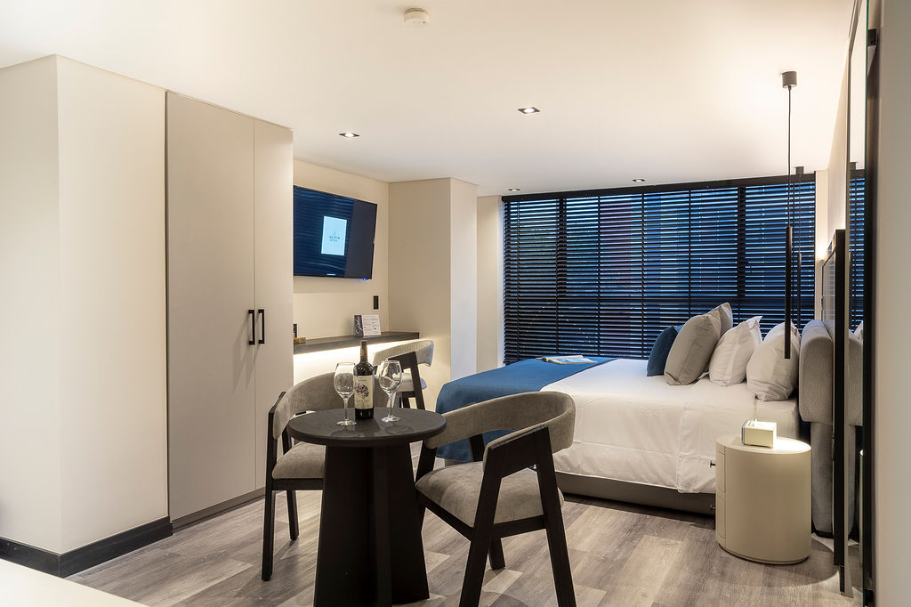 Suites insonorizadas con vista a la ciudad en hotel boutique premium Medellín, modelo Altus Urban con cocina privada y diseño contemporáneo
