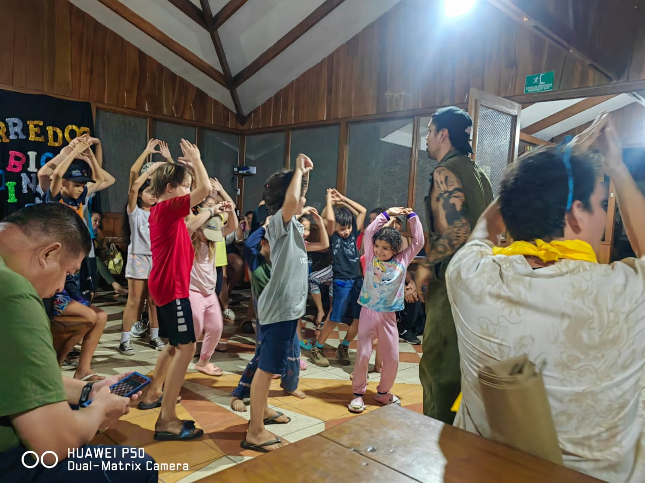 man in black crew neck t-shirt and blue shorts holding woman in white and red