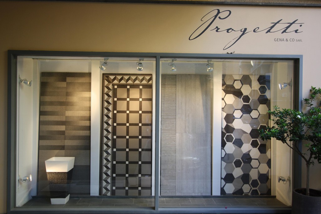 Street-facing window displaying tile panels