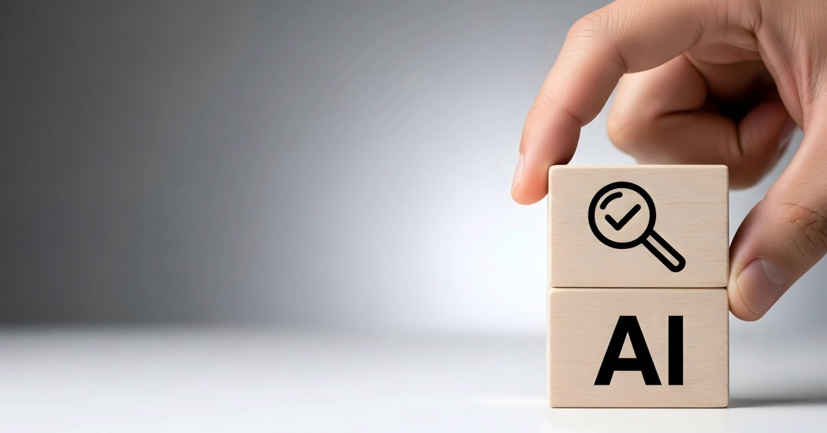 Hand placing wooden block with AI text and magnifying glass icon representing AI search visibility for New Hampshire businesses