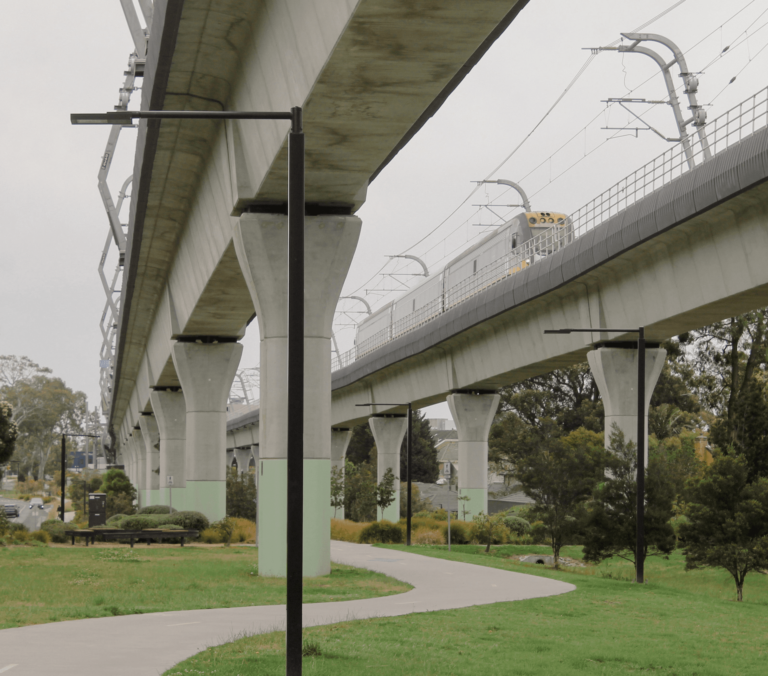 A bespoke light support bracket made of metal and painted yellow.