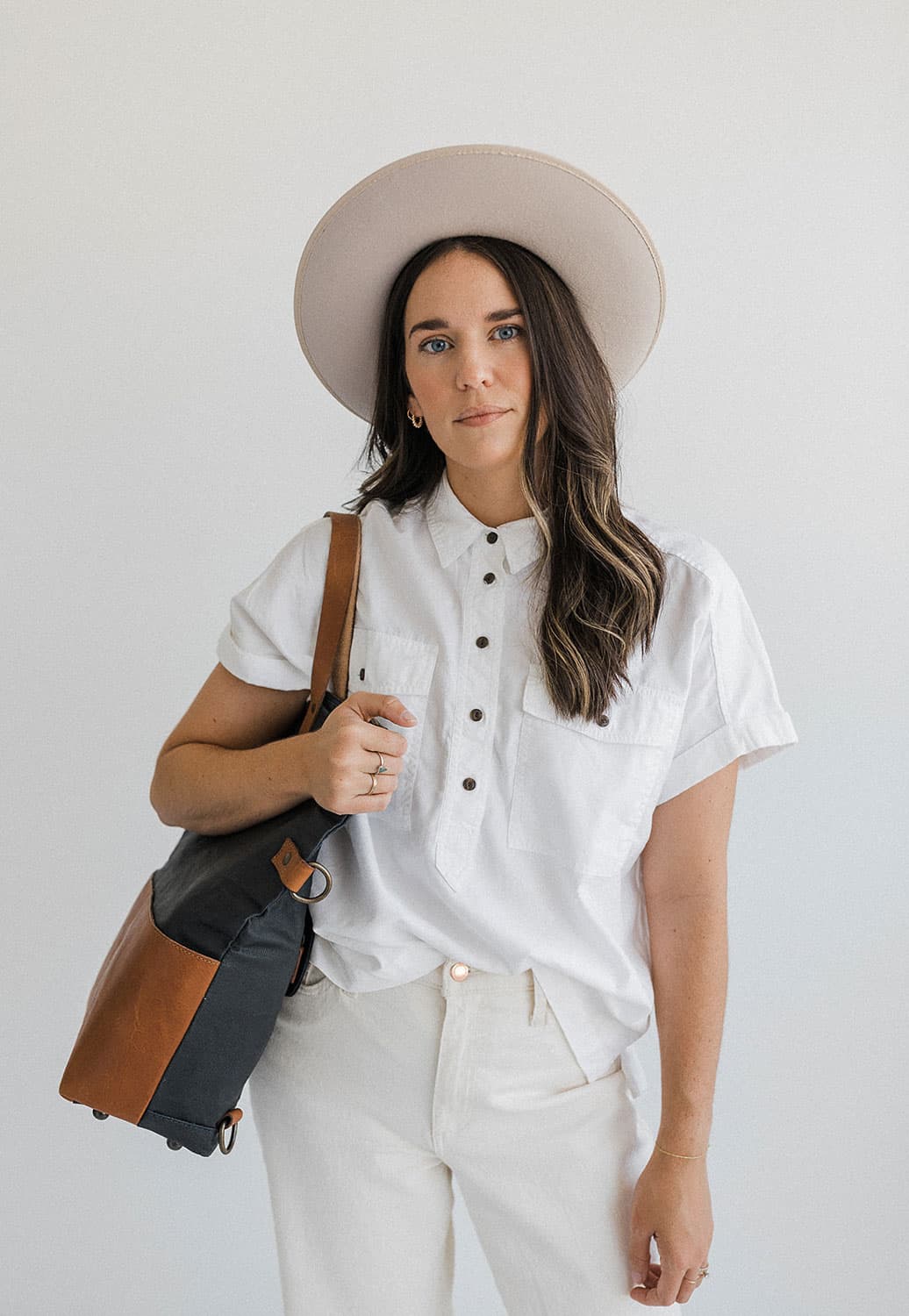 Megan Brunner standing confidently in the natural light-filled Revelator Studio, a premier photography studio in Shreveport, perfect for capturing high-quality images for creative professionals.