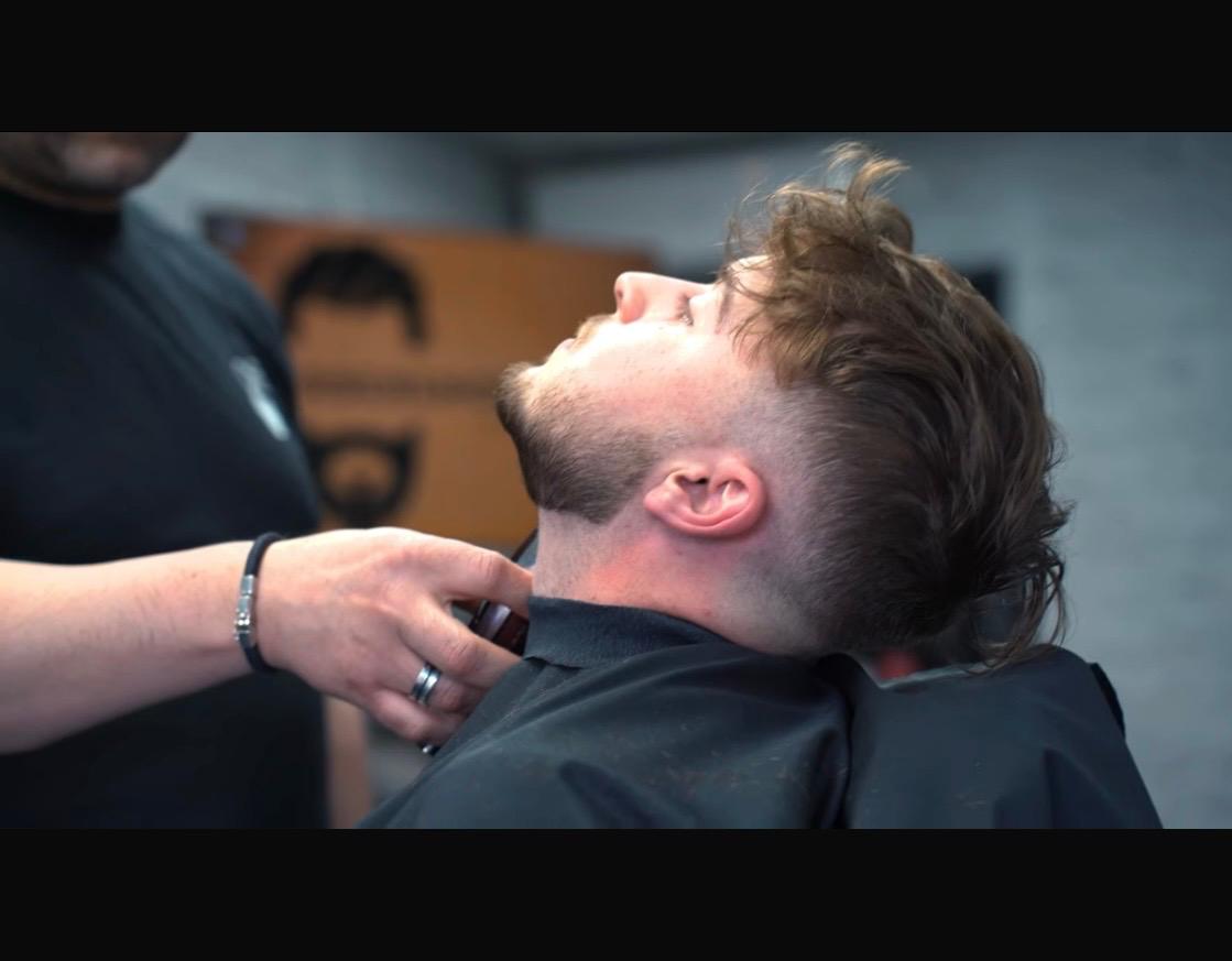 Barber drying client's beard