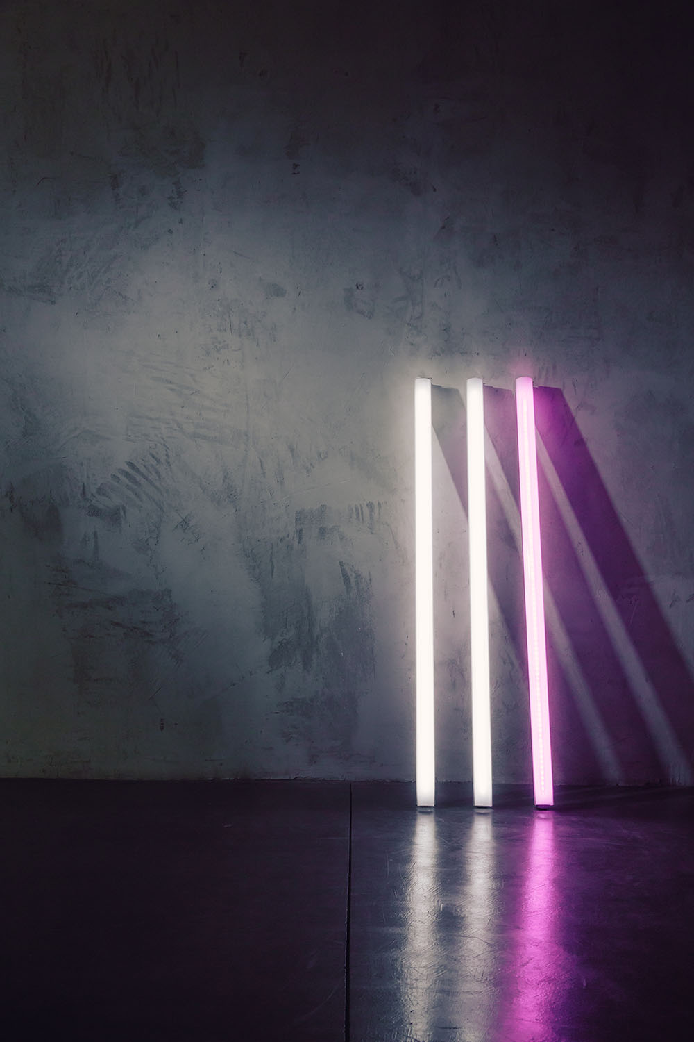 Digital Sputnik Voyagers illuminate the concrete wall texture at Particle Studios in Seattle, WA.