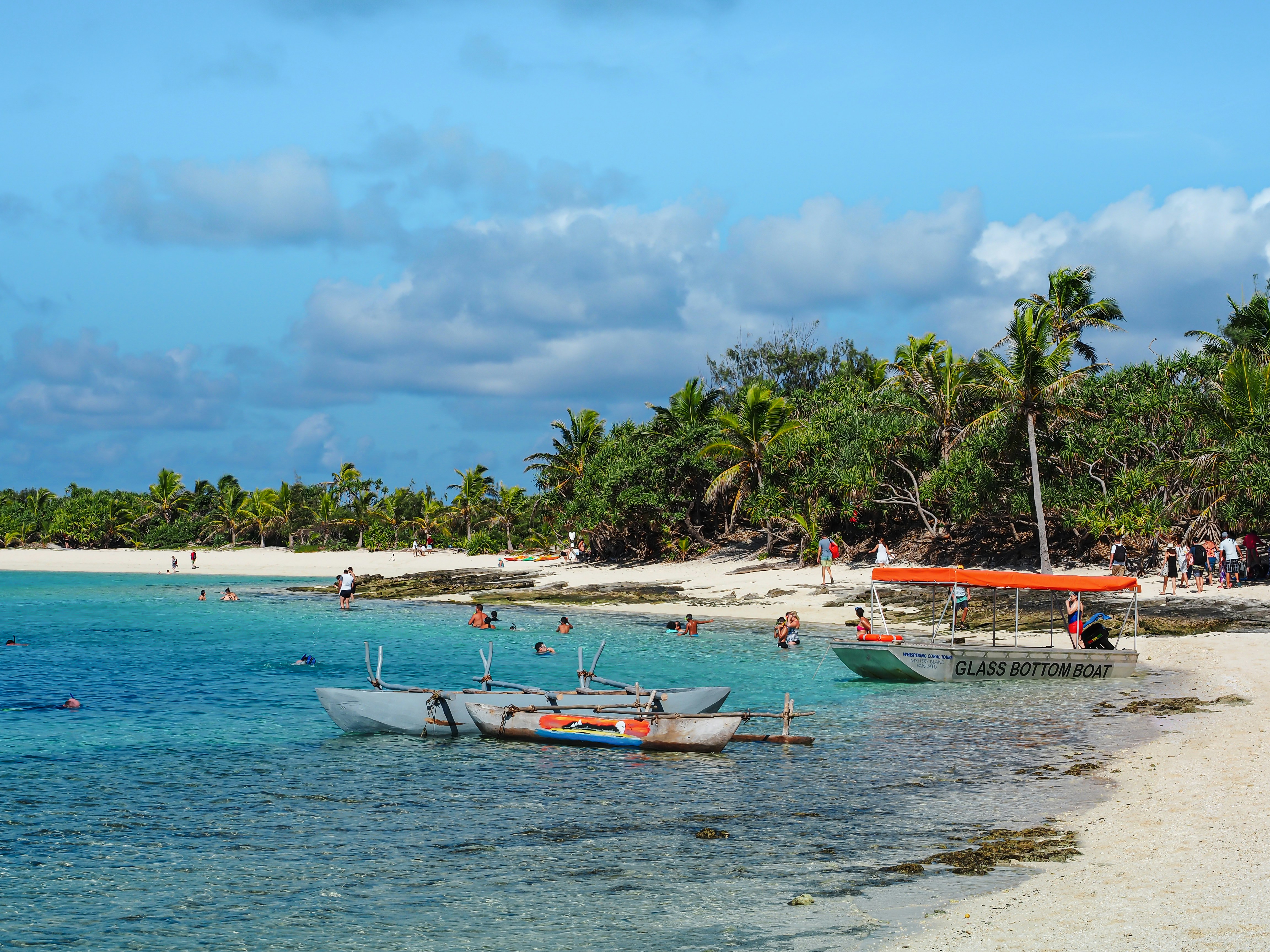 white and red boat on beach during daytime