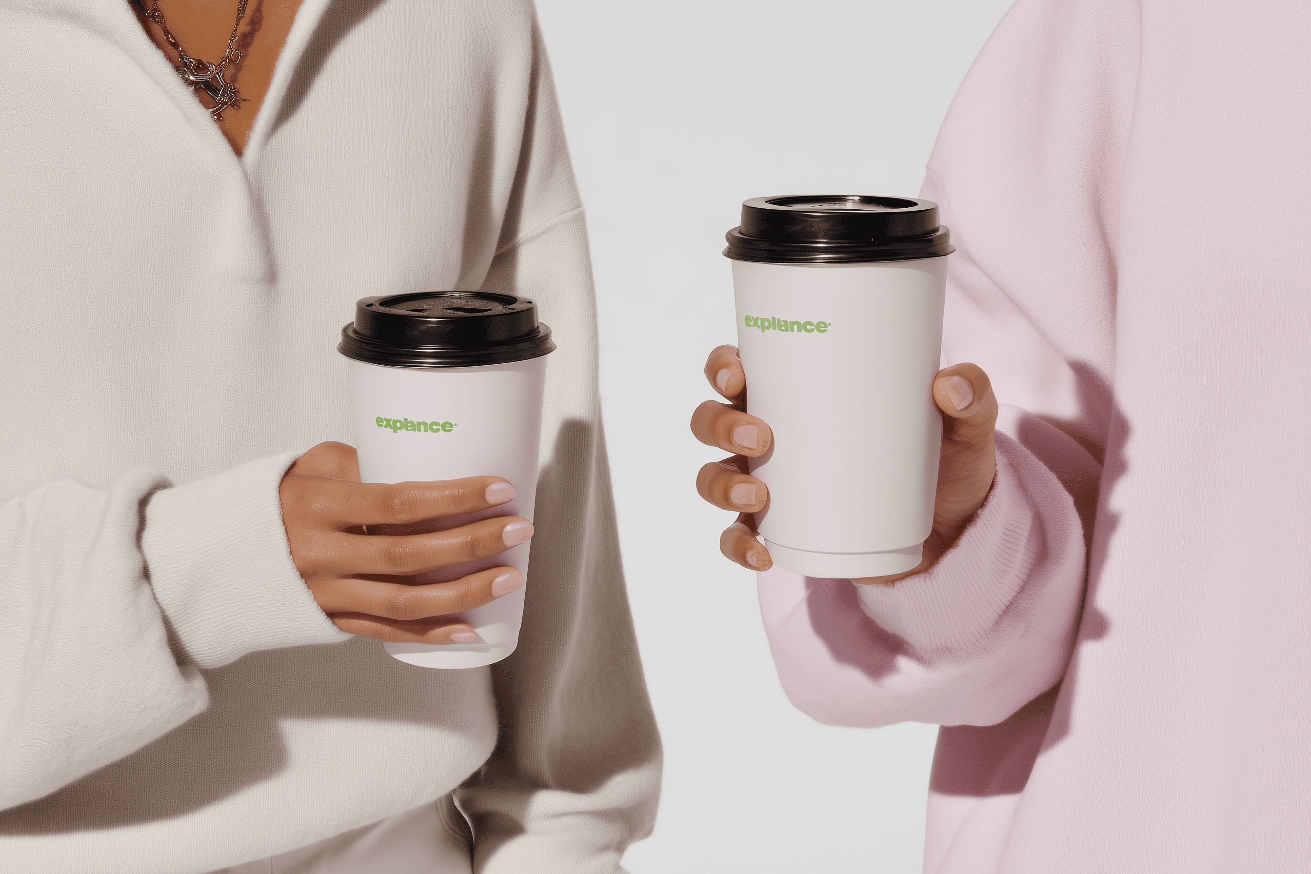 Hands holding a collection of colorful drink cups including matcha and pink coffee cups