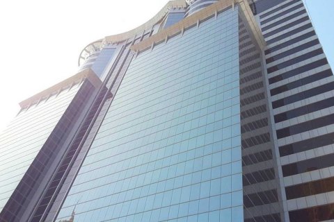 Modern blue glass exterior of SIT Tower, offering premium office spaces for businesses in Dubai.