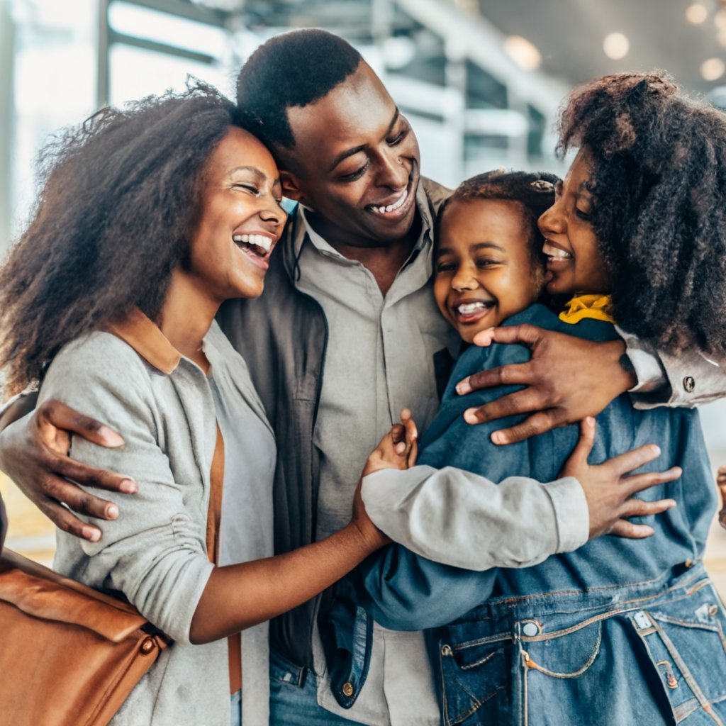 A photo of a happy family embracing, symbolizing the importance of family-based immigration and the joy of reuniting with loved ones.