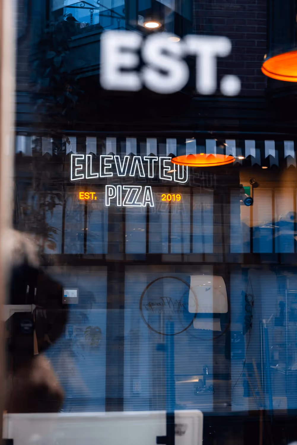 Elevated Pizza project photography featuring a branded vehicle and outdoor setting project feature