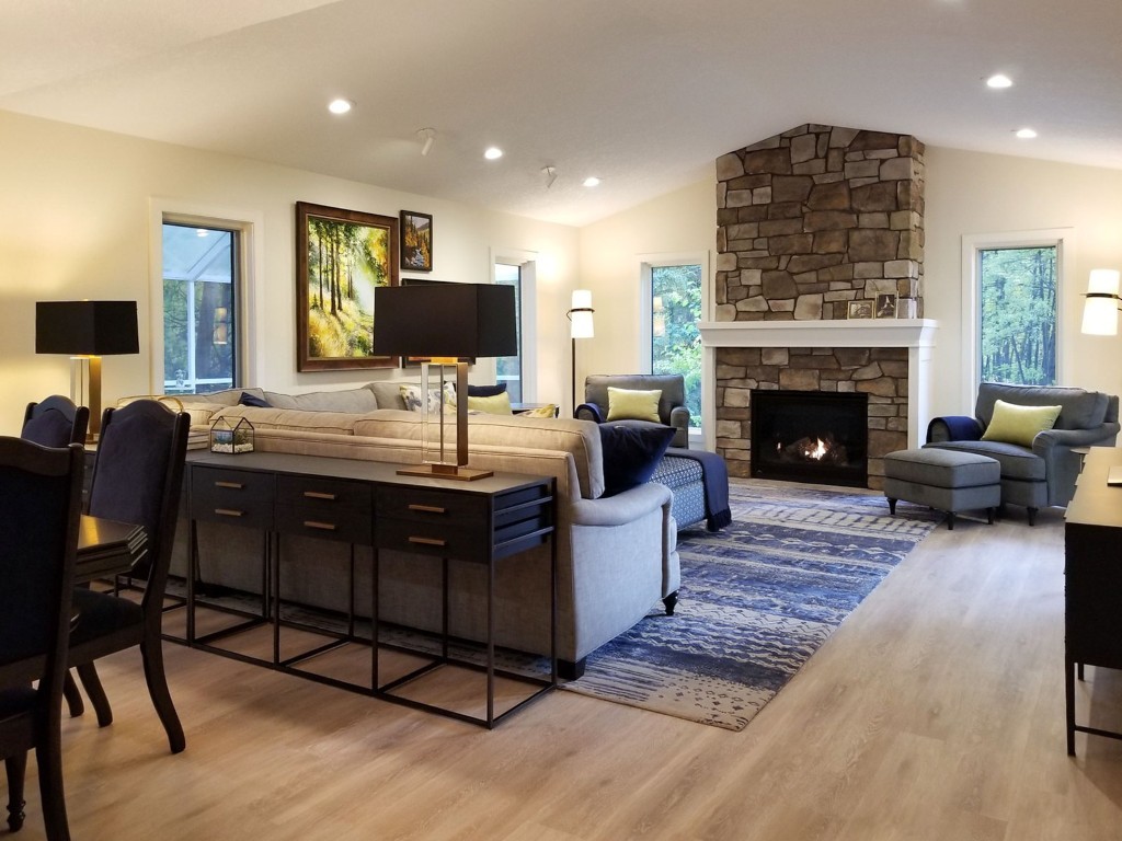 Image of Luxury living room interior design by KHD Homes featuring furniture, layout design, and stone fireplace.