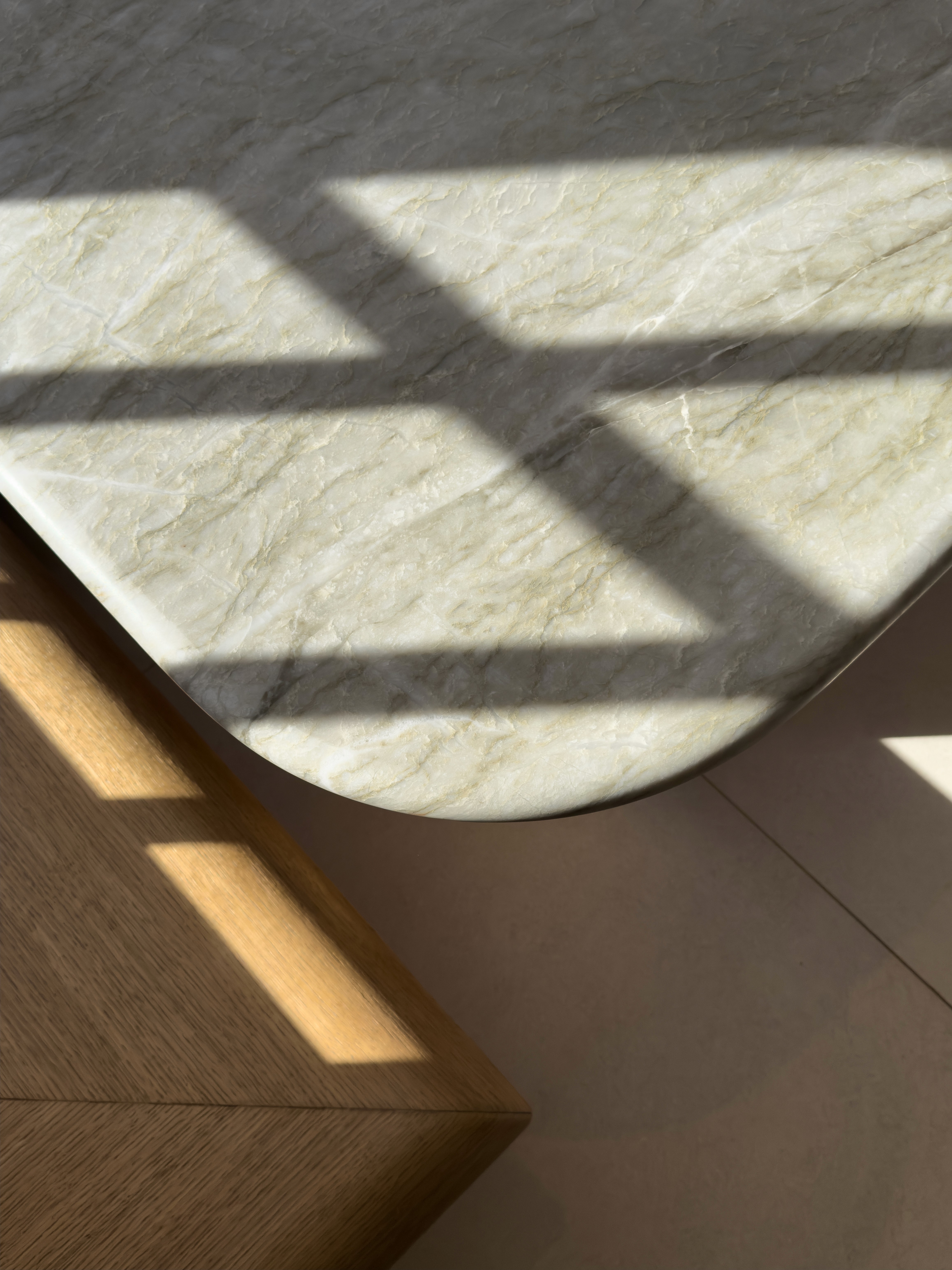 Geometric sunlight shadows across vancouver stone surface