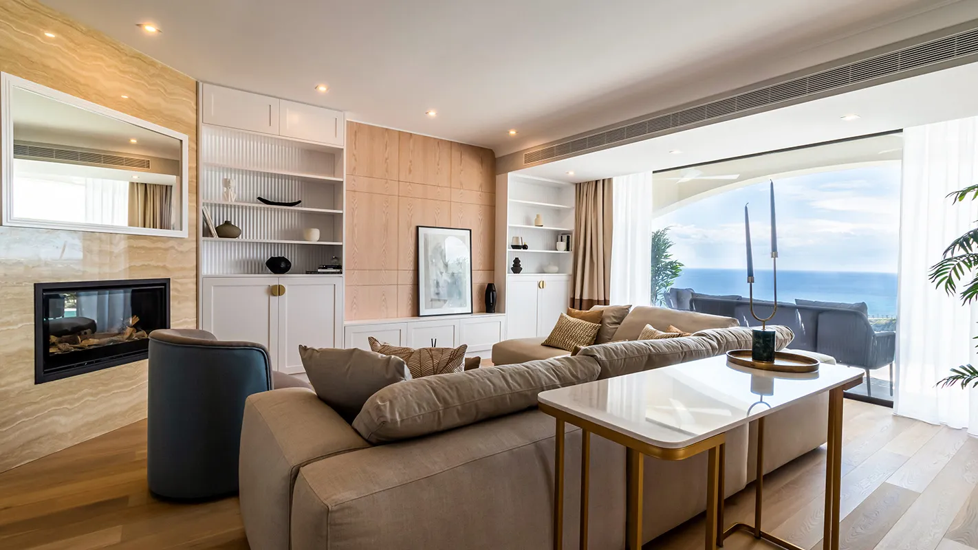 White Cedar House Mediterranean living room with built-in shelving, fireplace, and sea-view glazing
