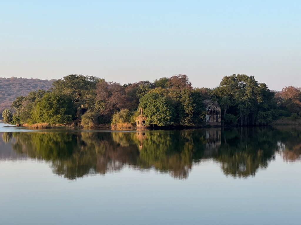A lake with a hunting lodge on its banks.