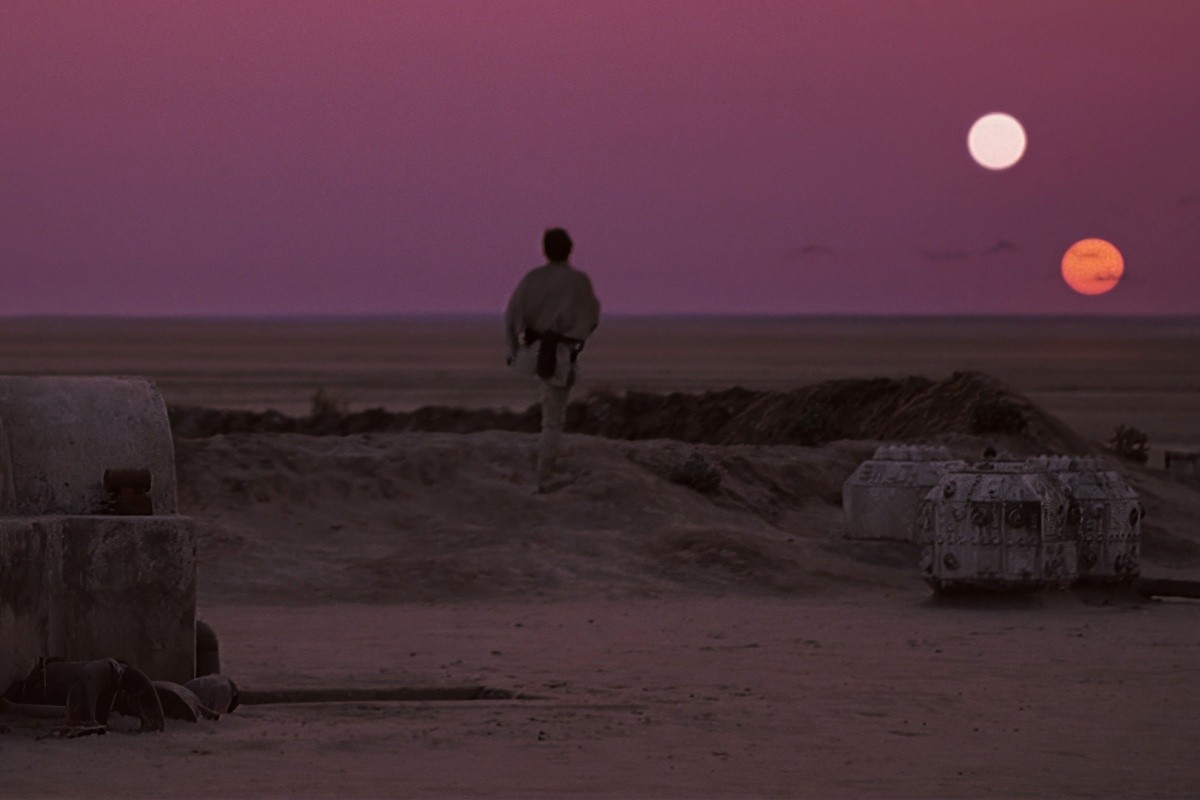 Luke Skywalker viewing the twin suns setting on Tatooine. 