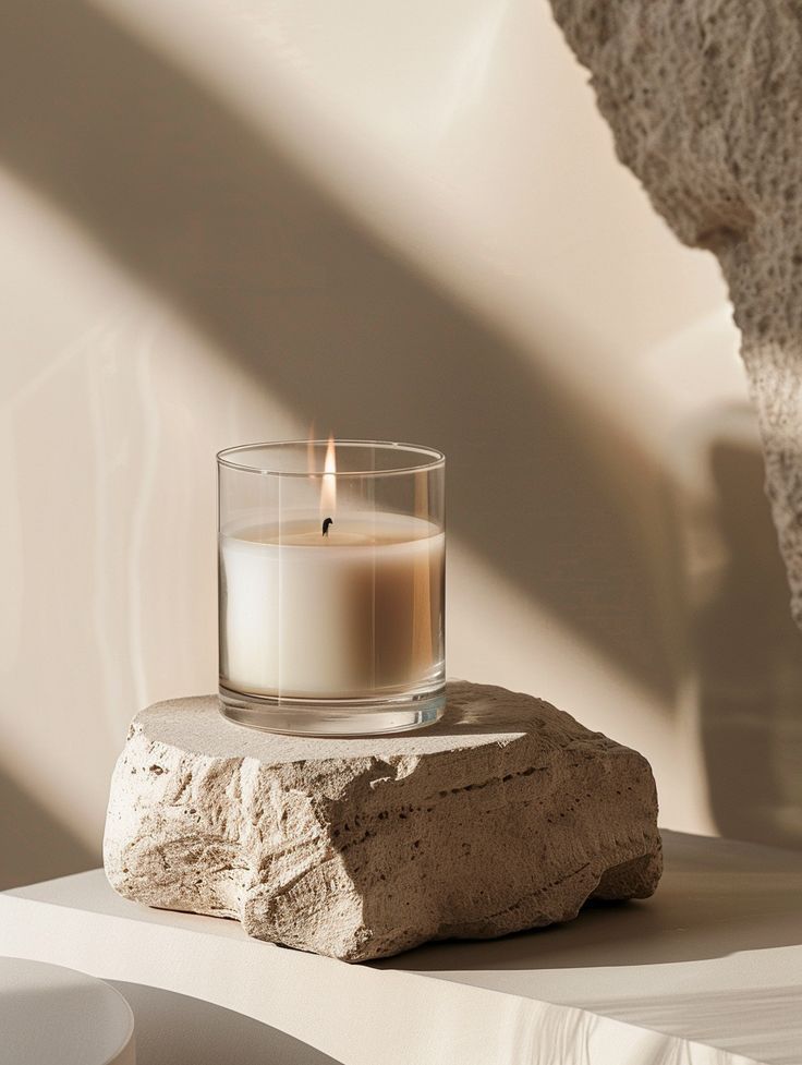 Confident woman in a tan suit holding a resume in a bright office, with colleagues working in the background.