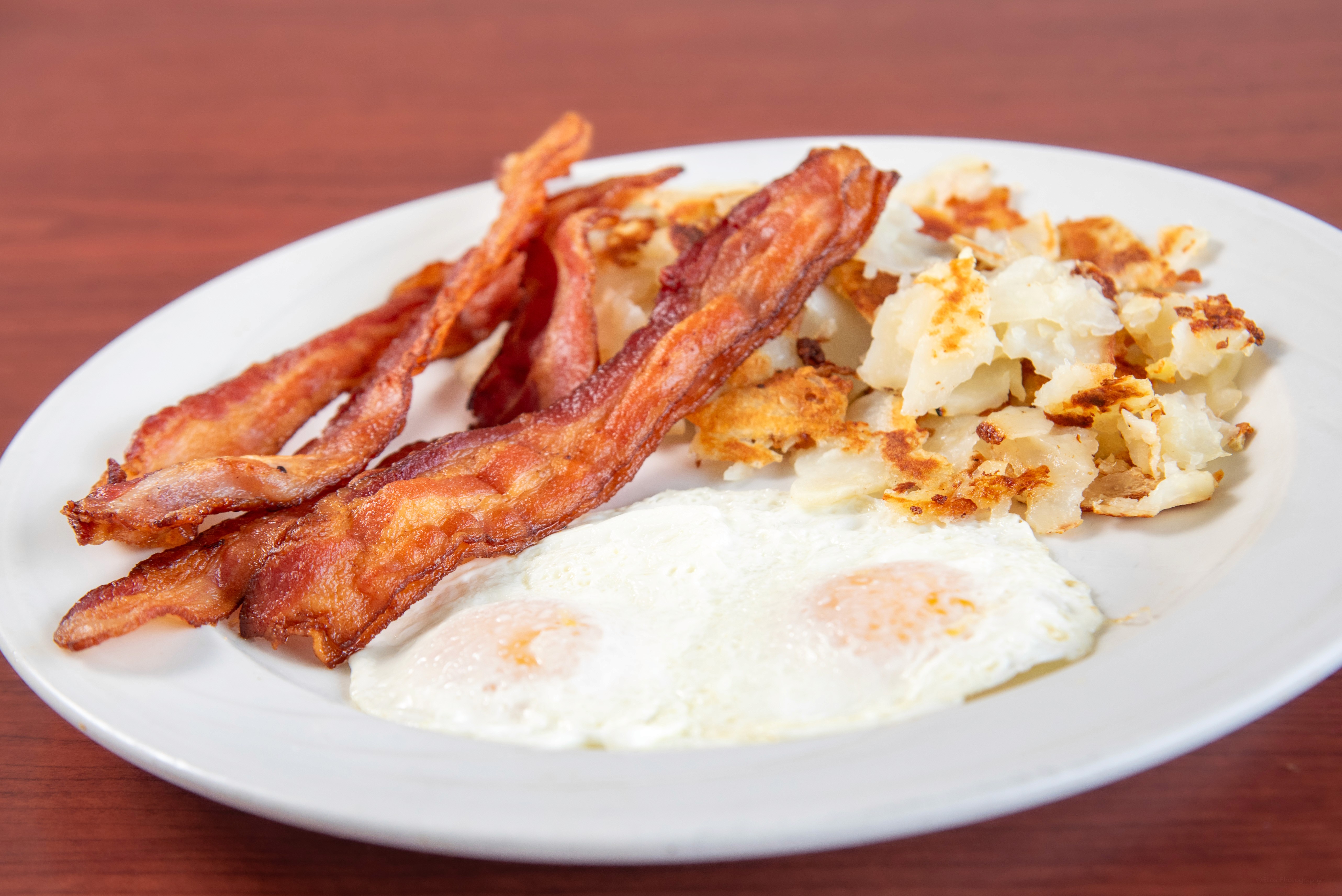 bread with sunny side-up egg served on white ceramic plate