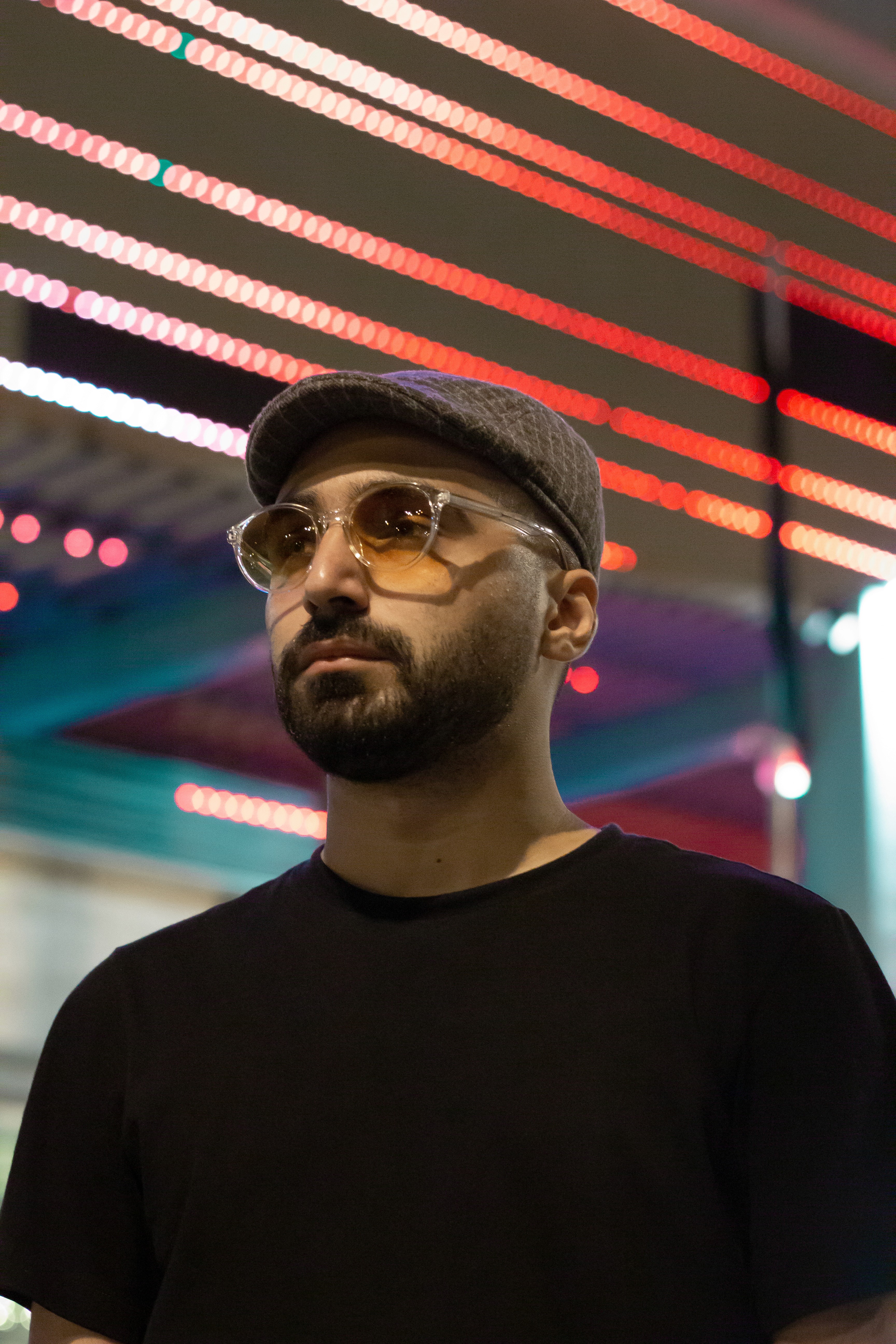 Close-up of a yellow tennis ball sitting on a green court, positioned near the white center line.