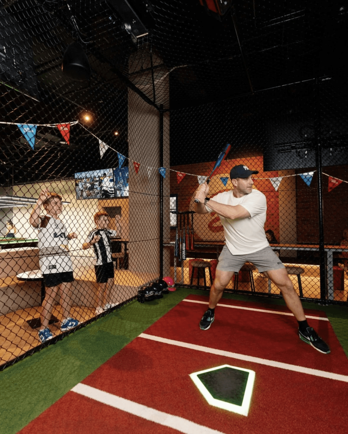 Player hitting area inside the Kotara HitTrax Suite showing mat, netting, and launch zone.