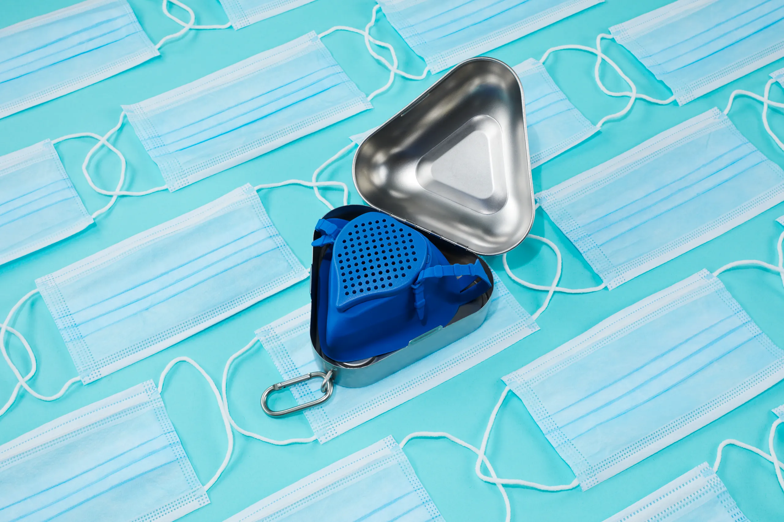 Open blue and silver CastleGrade PPE cases surrounded by disposable face masks