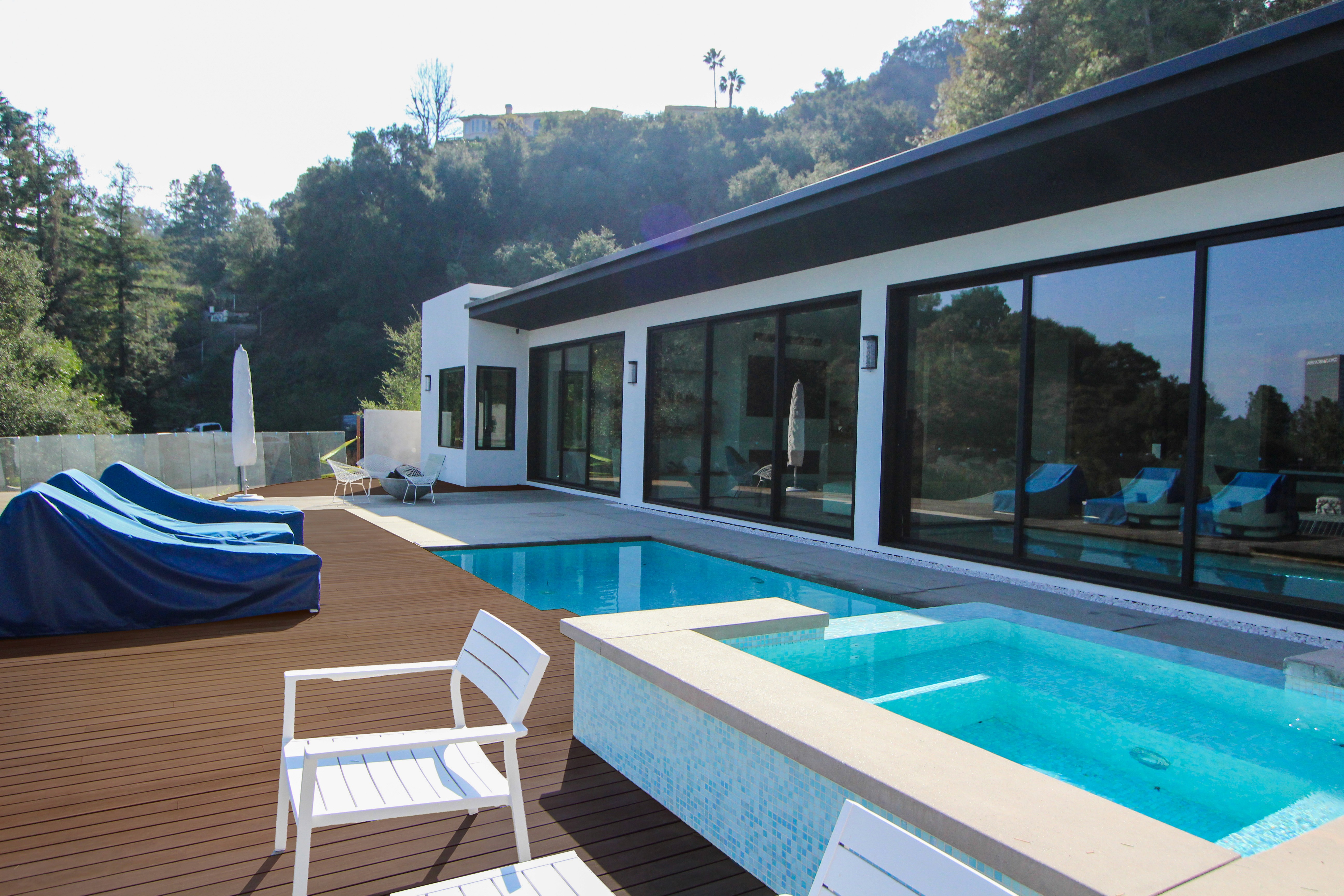 Exterior view of the modern home featuring a sleek pool.