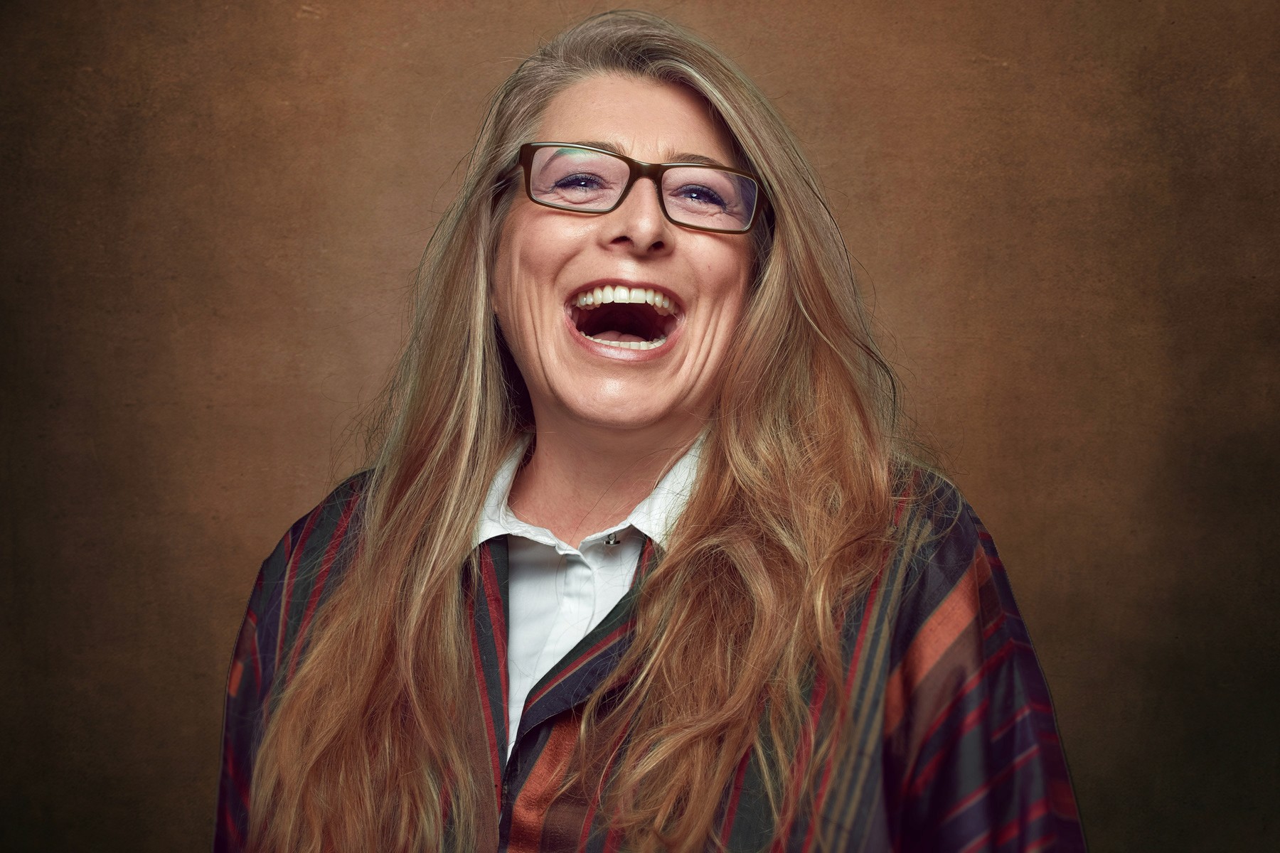 Team branding photo of seven professional women in black and white outfits standing confidently on waterfront patio with modern marina in background
