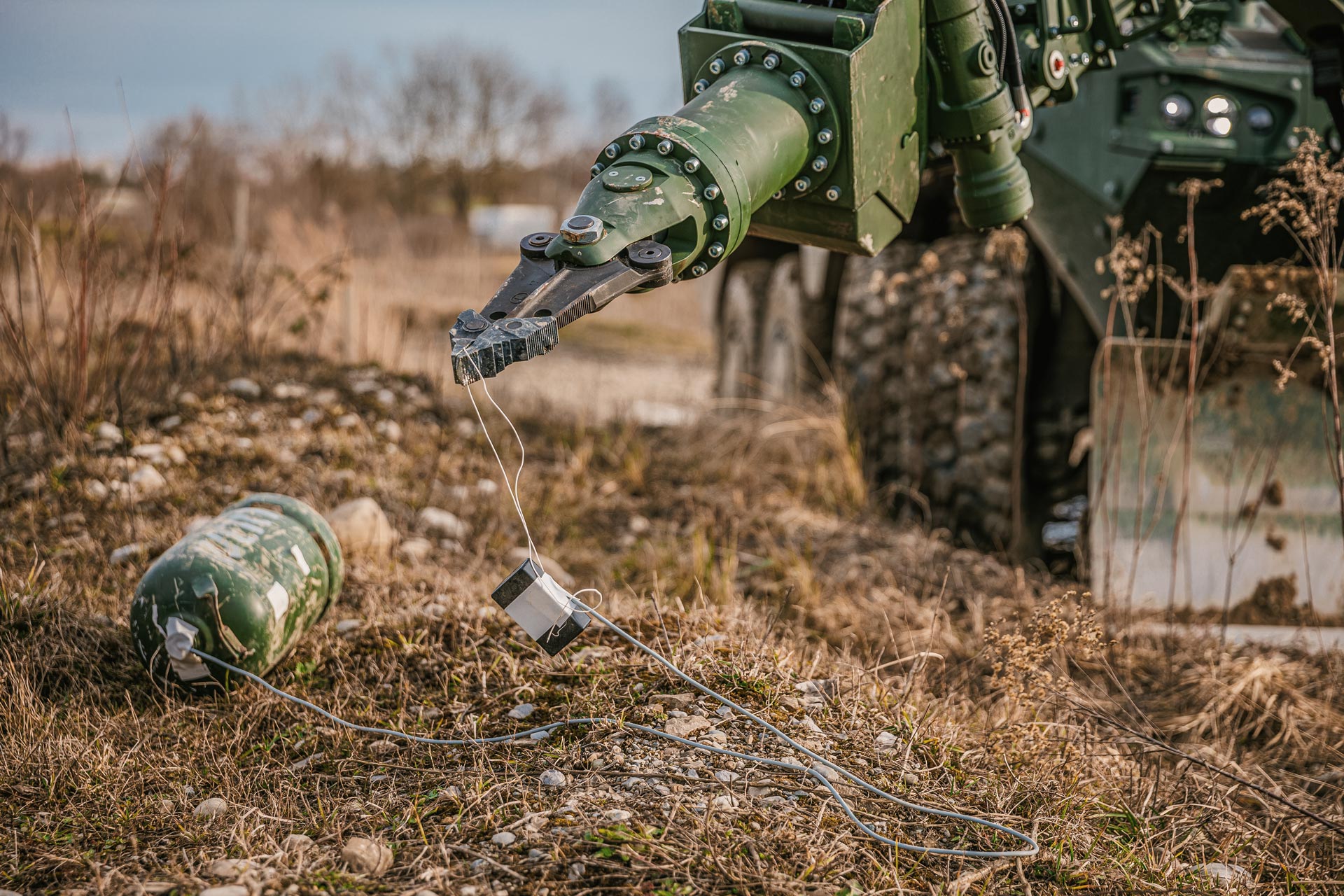 A GCS manipulator arm handling a suspected IED during IEDD operations.