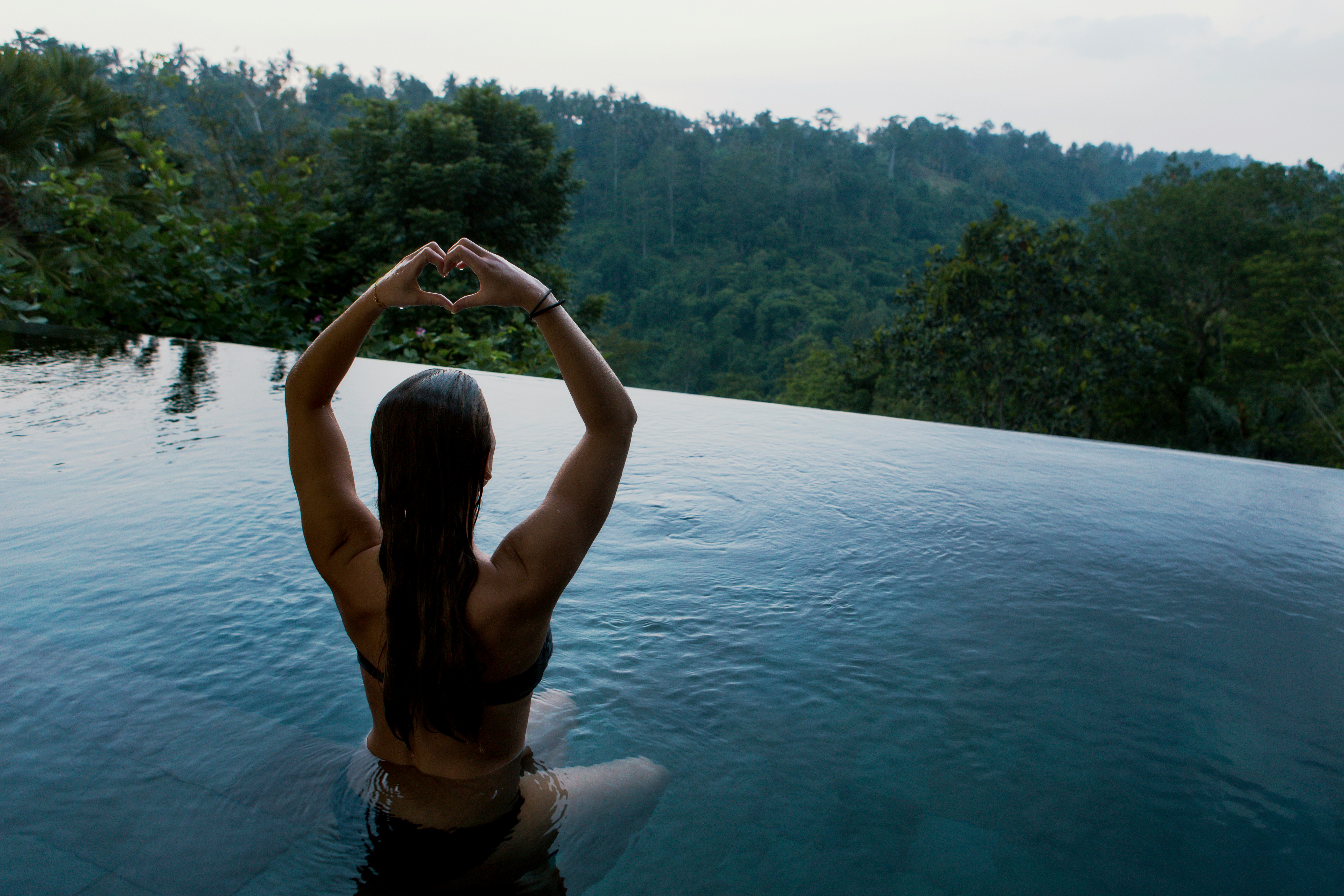 woman doing yoga in pool - How To Glow Up Physically